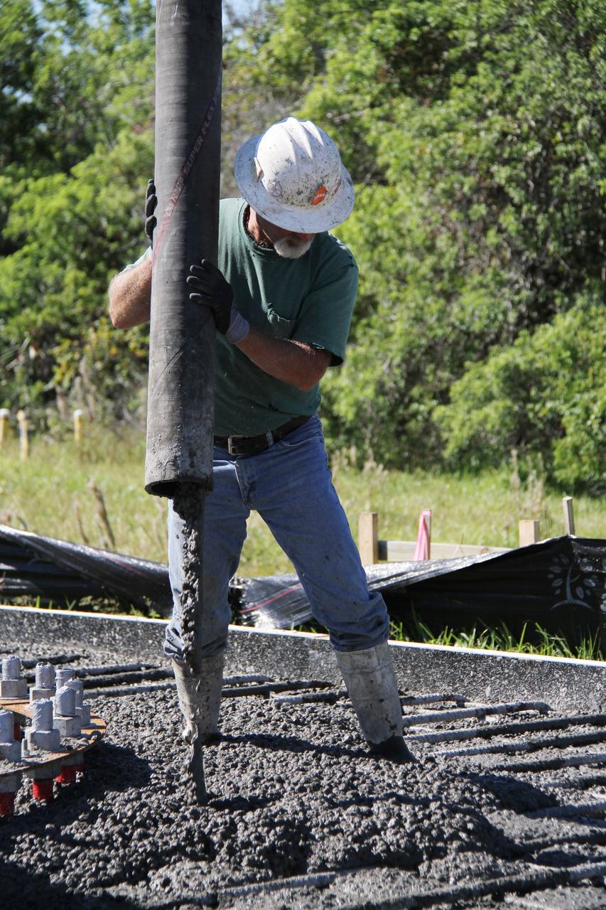 CAPE CANAVERAL, Fla. – At NASA’s Kennedy Space Center in Florida, a worker continues construction of the Antenna Test Bed Array for the Ka-Band Objects Observation and Monitoring, or Ka-BOOM, system.    The construction site is near the former Vertical Processing Facility, which has been demolished. Workers are placing the pile foundations for the 40-foot-diameter dish antenna arrays and their associated utilities, and preparing the site for the operations command center facility. Photo credit: NASA/Ben Smegelski