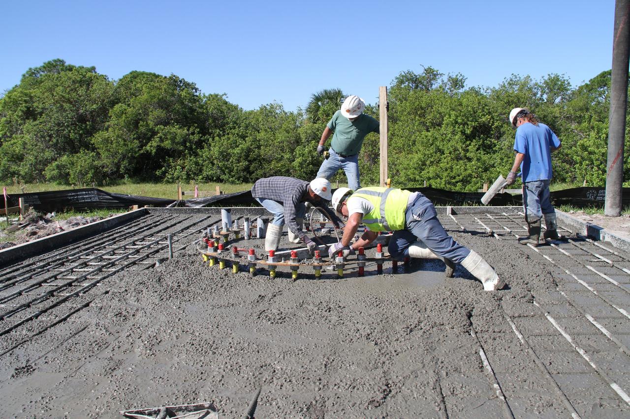 CAPE CANAVERAL, Fla. – At NASA’s Kennedy Space Center in Florida, workers continue construction of the Antenna Test Bed Array for the Ka-Band Objects Observation and Monitoring, or Ka-BOOM, system.    The construction site is near the former Vertical Processing Facility, which has been demolished. Workers are placing the pile foundations for the 40-foot-diameter dish antenna arrays and their associated utilities, and preparing the site for the operations command center facility. Photo credit: NASA/Ben Smegelski