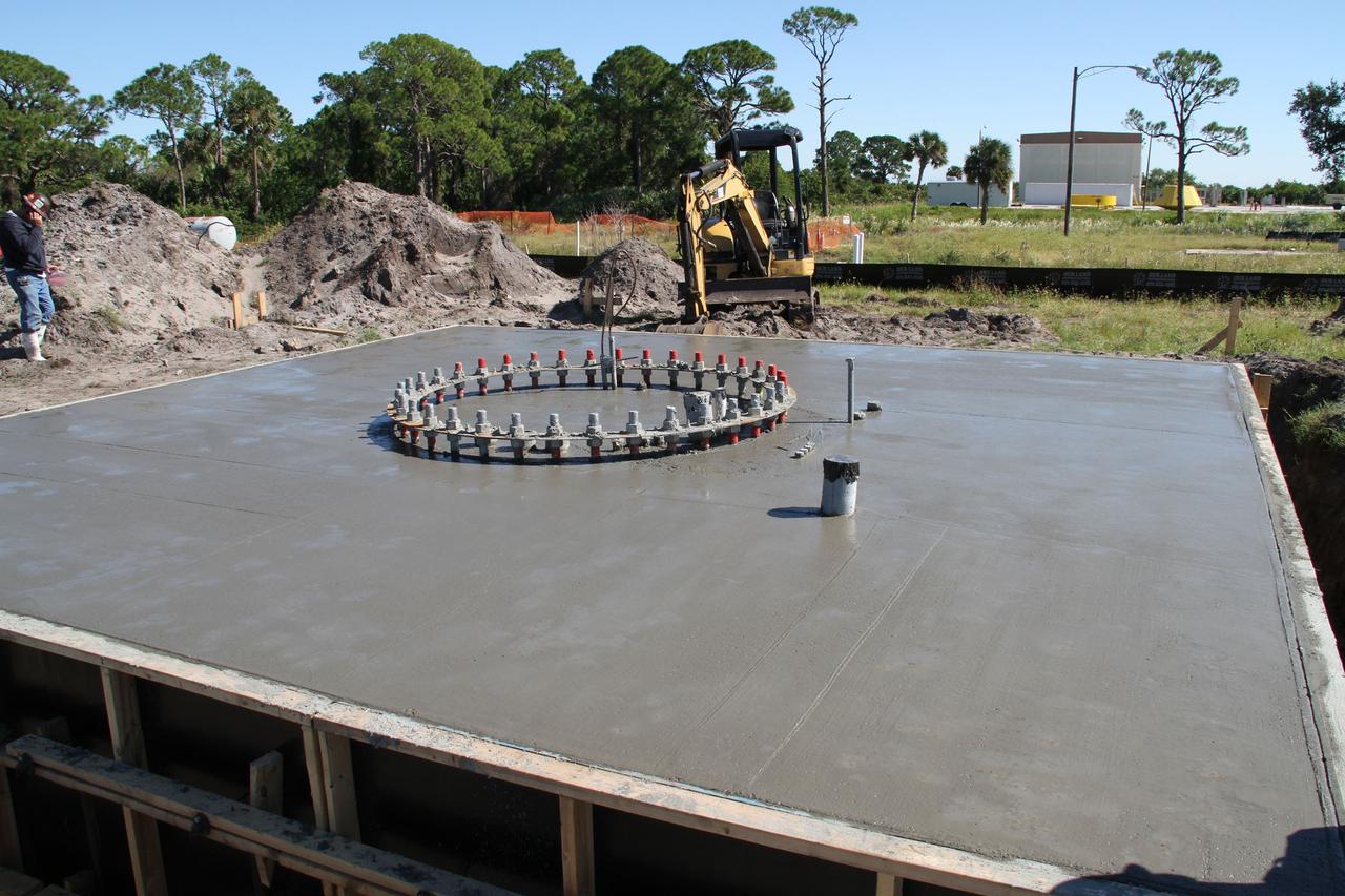 CAPE CANAVERAL, Fla. – At NASA’s Kennedy Space Center in Florida, concrete has been poured at the site of the Antenna Test Bed Array for the Ka-Band Objects Observation and Monitoring, Ka-BOOM system.    The construction site is near the former Vertical Processing Facility, which has been demolished. Workers are placing the pile foundations for the 40-foot-diameter dish antenna arrays and their associated utilities, and preparing the site for the operations command center facility. Photo credit: NASA/Ben Smegelski