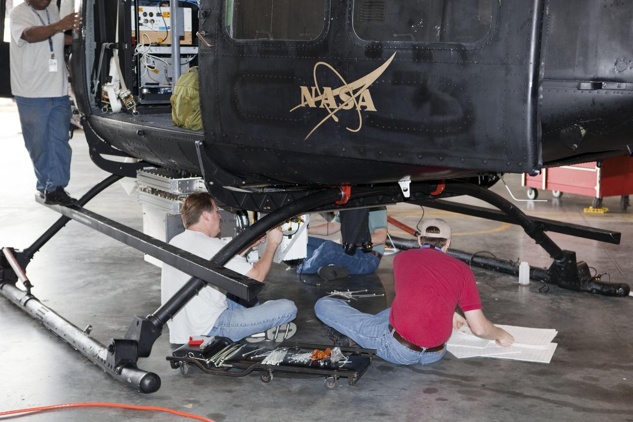 CAPE CANAVERAL, Fla. – Near the Shuttle Landing Facility at NASA's Kennedy Space Center in Florida, a space agency team installed and tested hazard avoidance instrumentation on a Huey helicopter. Led by the Johnson Space Center and supported by Jet Propulsion Laboratory and Langley Research Center, the Autonomous Landing Hazard Avoidance Technology, or ALHAT, laser system provides a planetary lander the ability to precisely land safely on a surface while detecting any dangerous obstacles such as rocks, holes and slopes. Just north of Kennedy's Shuttle Landing Facility runway, a rock- and crater-filled planetary scape has been built so engineers can test the ability to negotiate away from risks. Photo credit: NASA/Dmitri Gerondidakis