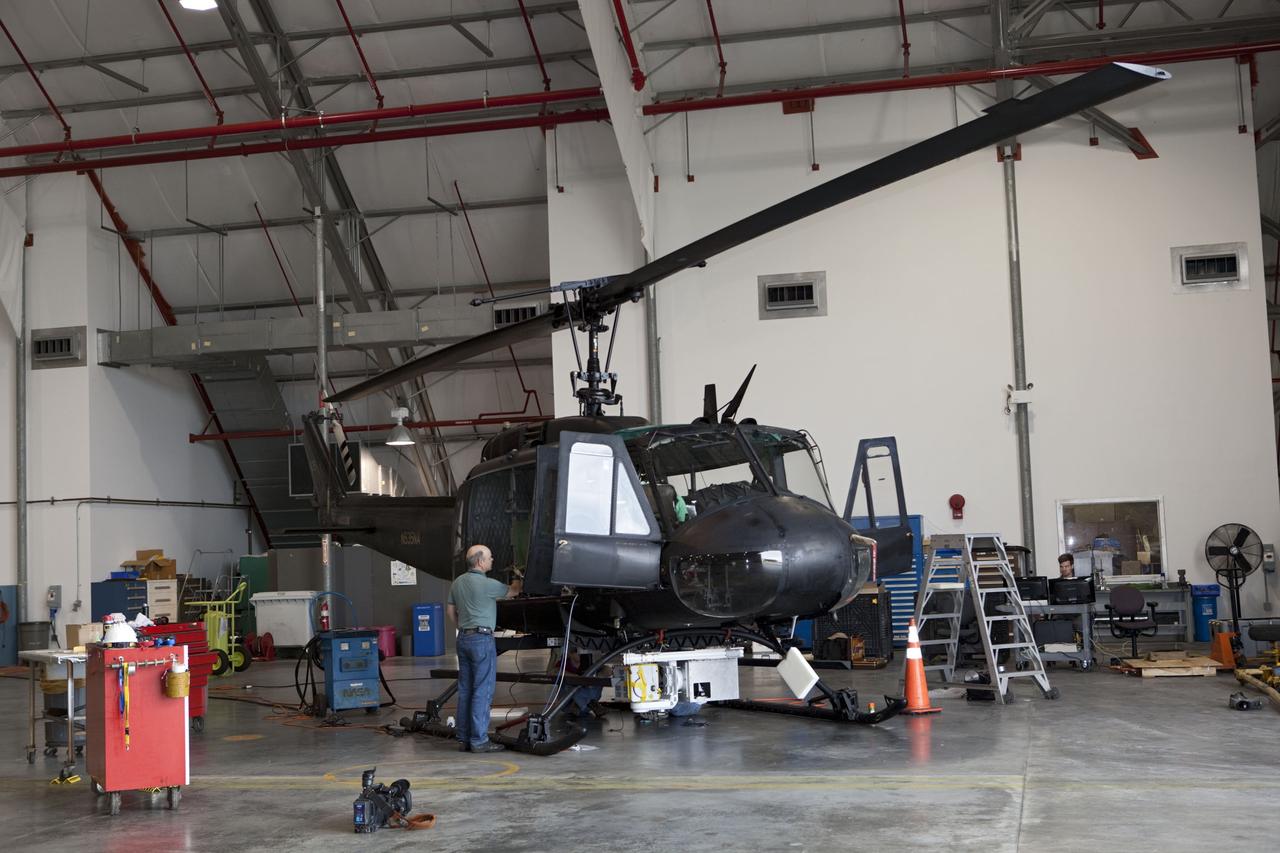 CAPE CANAVERAL, Fla. – Near the Shuttle Landing Facility at NASA's Kennedy Space Center in Florida, a space agency team installed and tested hazard avoidance instrumentation on a Huey helicopter. Led by the Johnson Space Center and supported by Jet Propulsion Laboratory and Langley Research Center, the Autonomous Landing Hazard Avoidance Technology, or ALHAT, laser system provides a planetary lander the ability to precisely land safely on a surface while detecting any dangerous obstacles such as rocks, holes and slopes. Just north of Kennedy's Shuttle Landing Facility runway, a rock- and crater-filled planetary scape has been built so engineers can test the ability to negotiate away from risks. Photo credit: NASA/Dmitri Gerondidakis