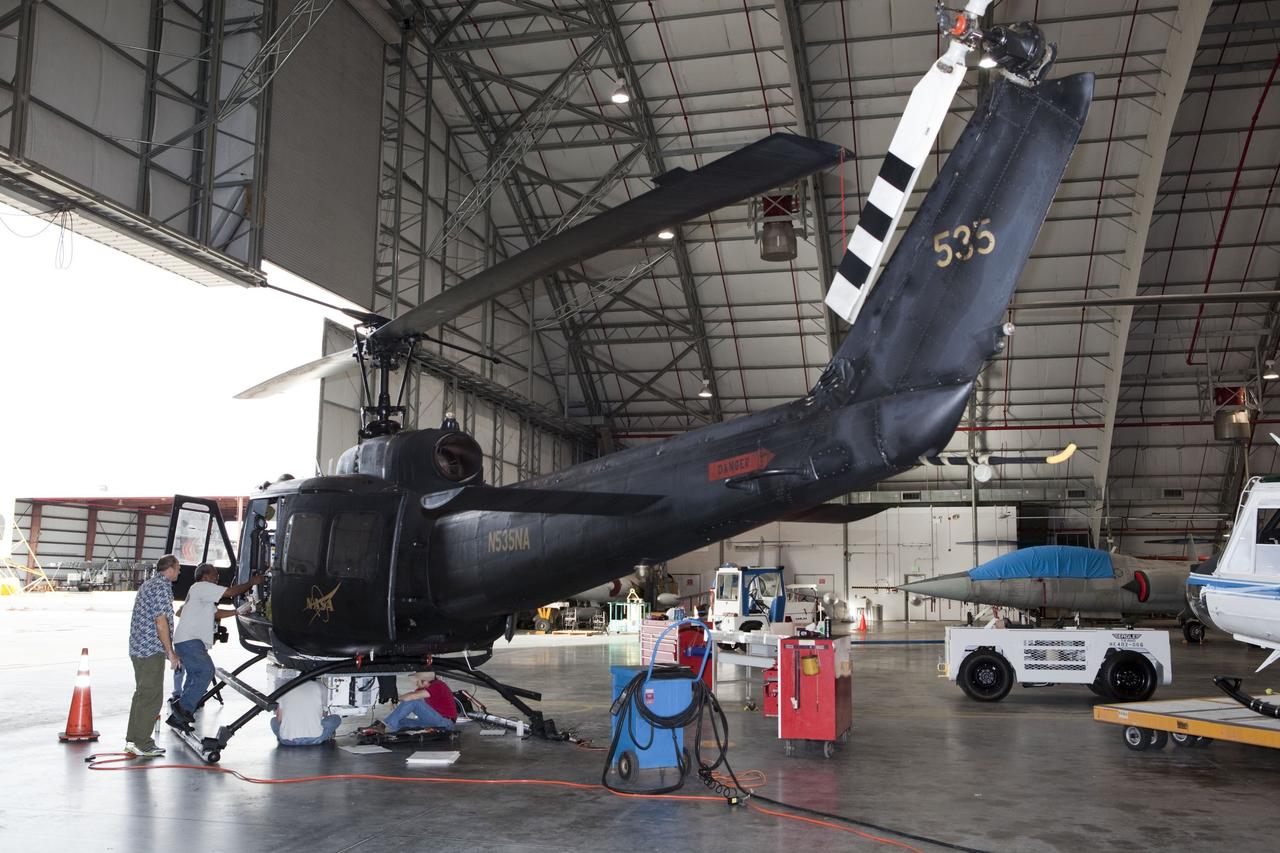 CAPE CANAVERAL, Fla. – Near the Shuttle Landing Facility at NASA's Kennedy Space Center in Florida, a space agency team installed and tested hazard avoidance instrumentation on a Huey helicopter. Led by the Johnson Space Center and supported by Jet Propulsion Laboratory and Langley Research Center, the Autonomous Landing Hazard Avoidance Technology, or ALHAT, laser system provides a planetary lander the ability to precisely land safely on a surface while detecting any dangerous obstacles such as rocks, holes and slopes. Just north of Kennedy's Shuttle Landing Facility runway, a rock- and crater-filled planetary scape has been built so engineers can test the ability to negotiate away from risks. Photo credit: NASA/Dmitri Gerondidakis
