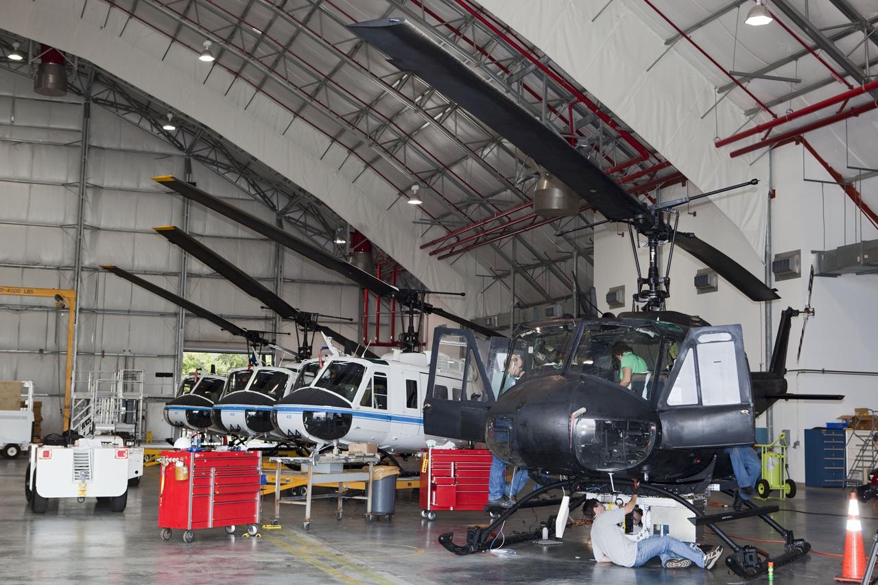 CAPE CANAVERAL, Fla. – Near the Shuttle Landing Facility at NASA's Kennedy Space Center in Florida, a space agency team installed and tested hazard avoidance instrumentation on a Huey helicopter. Led by the Johnson Space Center and supported by Jet Propulsion Laboratory and Langley Research Center, the Autonomous Landing Hazard Avoidance Technology, or ALHAT, laser system provides a planetary lander the ability to precisely land safely on a surface while detecting any dangerous obstacles such as rocks, holes and slopes. Just north of Kennedy's Shuttle Landing Facility runway, a rock- and crater-filled planetary scape has been built so engineers can test the ability to negotiate away from risks. Photo credit: NASA/Dmitri Gerondidakis