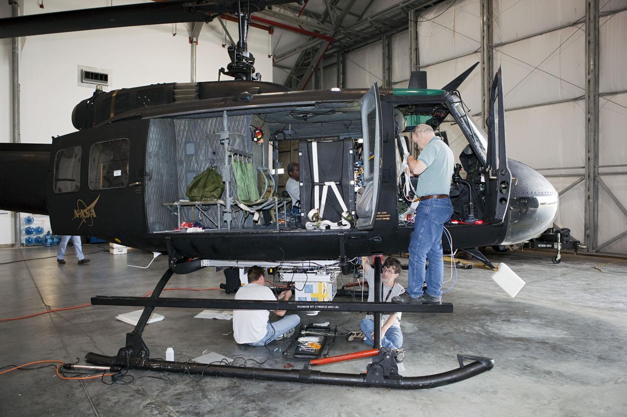 CAPE CANAVERAL, Fla. – Near the Shuttle Landing Facility at NASA's Kennedy Space Center in Florida, a space agency team installed and tested hazard avoidance instrumentation on a Huey helicopter. Led by the Johnson Space Center and supported by Jet Propulsion Laboratory and Langley Research Center, the Autonomous Landing Hazard Avoidance Technology, or ALHAT, laser system provides a planetary lander the ability to precisely land safely on a surface while detecting any dangerous obstacles such as rocks, holes and slopes. Just north of Kennedy's Shuttle Landing Facility runway, a rock- and crater-filled planetary scape has been built so engineers can test the ability to negotiate away from risks. Photo credit: NASA/Dmitri Gerondidakis