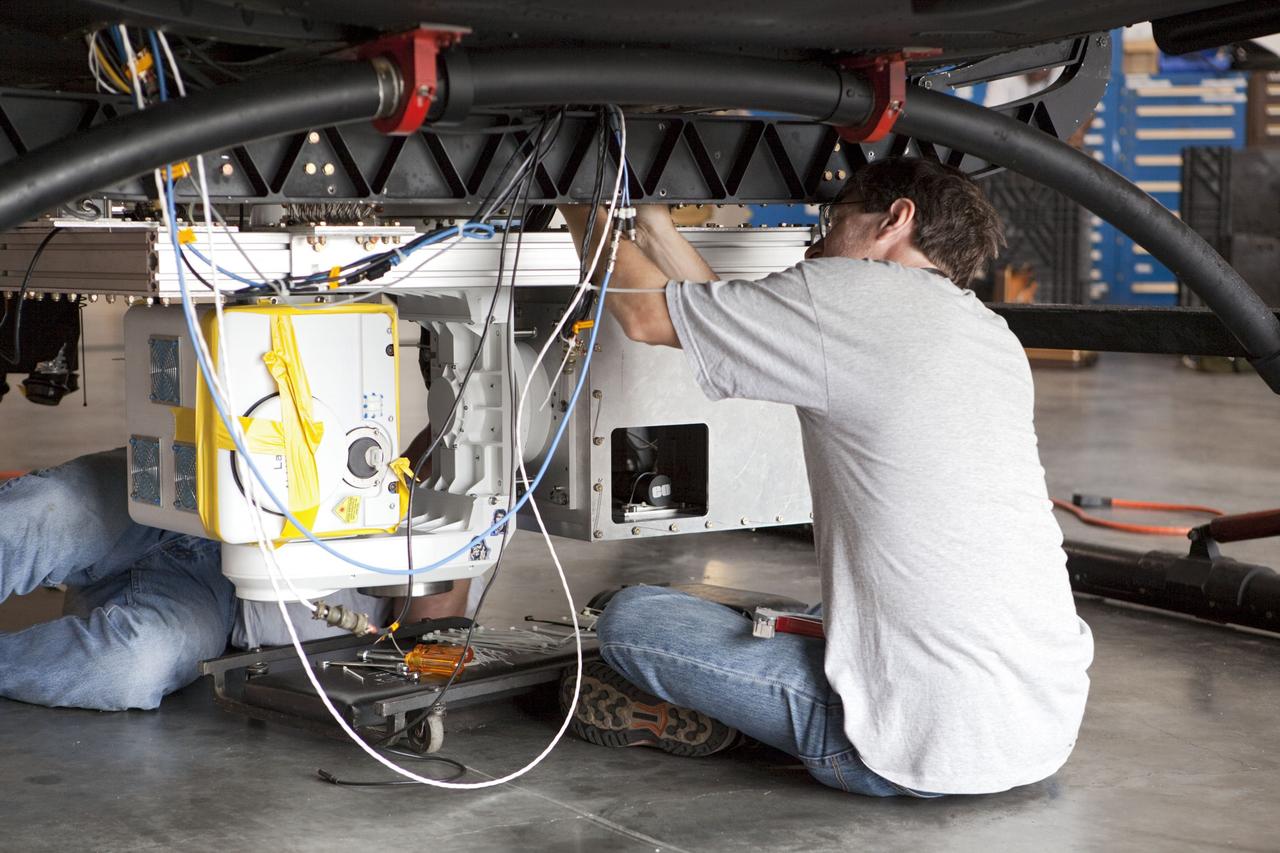 CAPE CANAVERAL, Fla. – Near the Shuttle Landing Facility at NASA's Kennedy Space Center in Florida, a space agency team installed and tested hazard avoidance instrumentation on a Huey helicopter. Led by the Johnson Space Center and supported by Jet Propulsion Laboratory and Langley Research Center, the Autonomous Landing Hazard Avoidance Technology, or ALHAT, laser system provides a planetary lander the ability to precisely land safely on a surface while detecting any dangerous obstacles such as rocks, holes and slopes. Just north of Kennedy's Shuttle Landing Facility runway, a rock- and crater-filled planetary scape has been built so engineers can test the ability to negotiate away from risks. Photo credit: NASA/Dmitri Gerondidakis