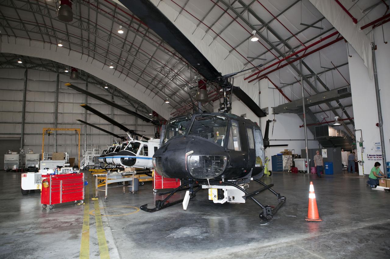 CAPE CANAVERAL, Fla. – Near the Shuttle Landing Facility at NASA's Kennedy Space Center in Florida, a space agency team installed and tested hazard avoidance instrumentation on a Huey helicopter. Led by the Johnson Space Center and supported by Jet Propulsion Laboratory and Langley Research Center, the Autonomous Landing Hazard Avoidance Technology, or ALHAT, laser system provides a planetary lander the ability to precisely land safely on a surface while detecting any dangerous obstacles such as rocks, holes and slopes. Just north of Kennedy's Shuttle Landing Facility runway, a rock- and crater-filled planetary scape has been built so engineers can test the ability to negotiate away from risks. Photo credit: NASA/Dmitri Gerondidakis