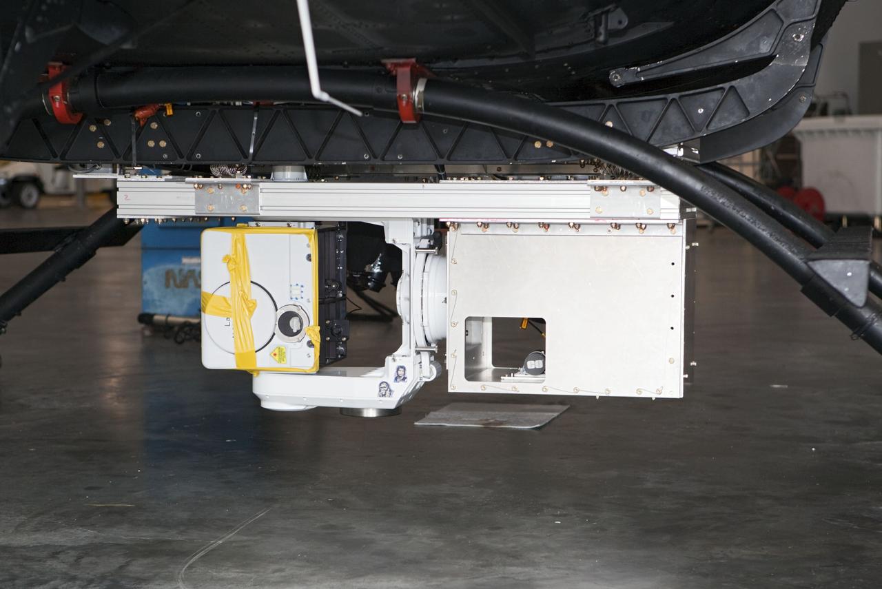 CAPE CANAVERAL, Fla. – Near the Shuttle Landing Facility at NASA's Kennedy Space Center in Florida, a space agency team installed and tested hazard avoidance instrumentation on a Huey helicopter. Led by the Johnson Space Center and supported by Jet Propulsion Laboratory and Langley Research Center, the Autonomous Landing Hazard Avoidance Technology, or ALHAT, laser system provides a planetary lander the ability to precisely land safely on a surface while detecting any dangerous obstacles such as rocks, holes and slopes. Just north of Kennedy's Shuttle Landing Facility runway, a rock- and crater-filled planetary scape has been built so engineers can test the ability to negotiate away from risks. Photo credit: NASA/Dmitri Gerondidakis