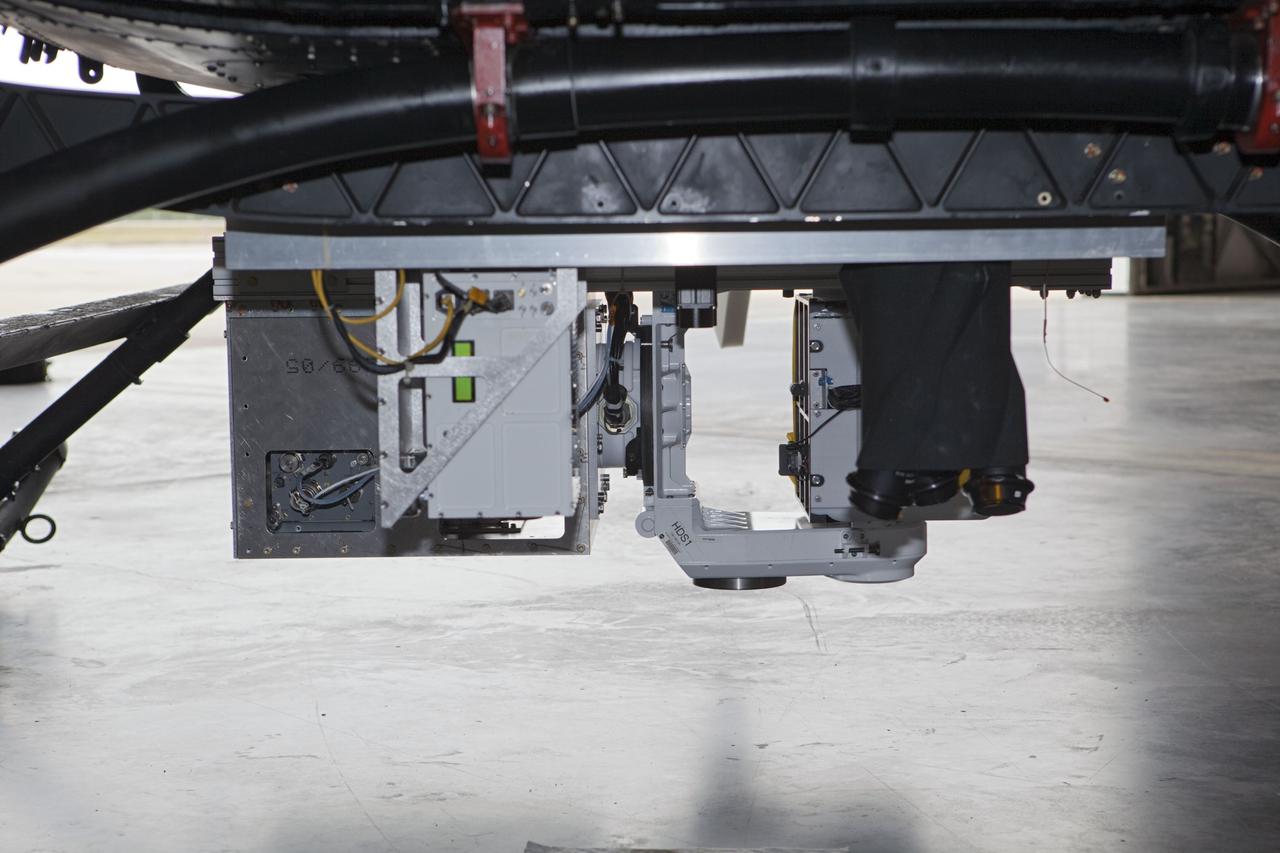 CAPE CANAVERAL, Fla. – Near the Shuttle Landing Facility at NASA's Kennedy Space Center in Florida, a space agency team installed and tested hazard avoidance instrumentation on a Huey helicopter. Led by the Johnson Space Center and supported by Jet Propulsion Laboratory and Langley Research Center, the Autonomous Landing Hazard Avoidance Technology, or ALHAT, laser system provides a planetary lander the ability to precisely land safely on a surface while detecting any dangerous obstacles such as rocks, holes and slopes. Just north of Kennedy's Shuttle Landing Facility runway, a rock- and crater-filled planetary scape has been built so engineers can test the ability to negotiate away from risks. Photo credit: NASA/Dmitri Gerondidakis