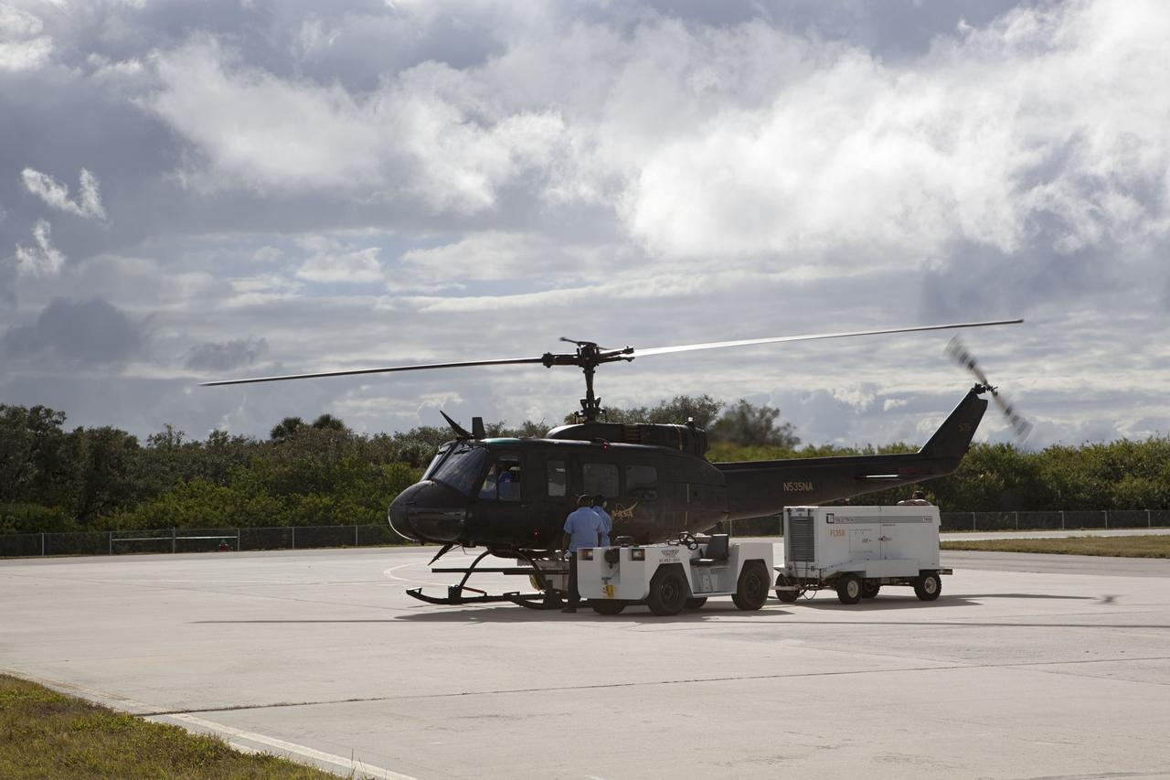 CAPE CANAVERAL, Fla. – Near the Shuttle Landing Facility at NASA's Kennedy Space Center in Florida, a space agency team installed and tested hazard avoidance instrumentation on a Huey helicopter. Led by the Johnson Space Center and supported by Jet Propulsion Laboratory and Langley Research Center, the Autonomous Landing Hazard Avoidance Technology, or ALHAT, laser system provides a planetary lander the ability to precisely land safely on a surface while detecting any dangerous obstacles such as rocks, holes and slopes. Just north of Kennedy's Shuttle Landing Facility runway, a rock- and crater-filled planetary scape has been built so engineers can test the ability to negotiate away from risks. Photo credit: NASA/Dmitri Gerondidakis
