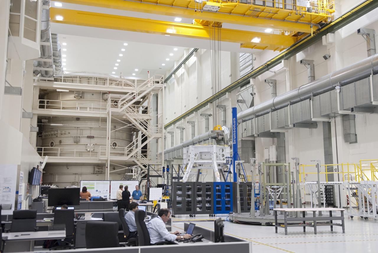 CAPE CANAVERAL, Fla. – Technicians prepare to lift a special fixture inside the high bay of the Operations & Checkout Building at NASA's Kennedy Space Center in Florida. The fixture is designed to enable precise pre-launch processing of the Orion spacecraft. An Orion capsule is being prepared to make a flight test in 2014 on a mission that will not carry any astronauts. Photo by Tim Jacobs