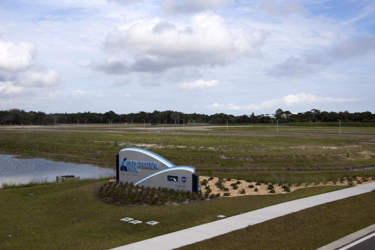 CAPE CANAVERAL, Fla. - A new sign on Space Commerce Way marks the entrance to Exploration Park near NASA’s Kennedy space Center in Florida. Land in the background has been cleared for the first phase of construction. Exploration Park encompasses 60 acres just outside Kennedy’s security gates. The park is designed to be a strategically located complex, adjacent to the Space Life Sciences Laboratory, for servicing diverse tenants and uses that will engage in activities to support the space-related activities of NASA, other government agencies and the U.S. commercial space industry. Its nine sustainable, state-of-the art buildings will include educational, office, research and laboratory, and high bay facilities and provide 350,000-square-feet of work space. Photo credit: NASA/Jim Grossmann