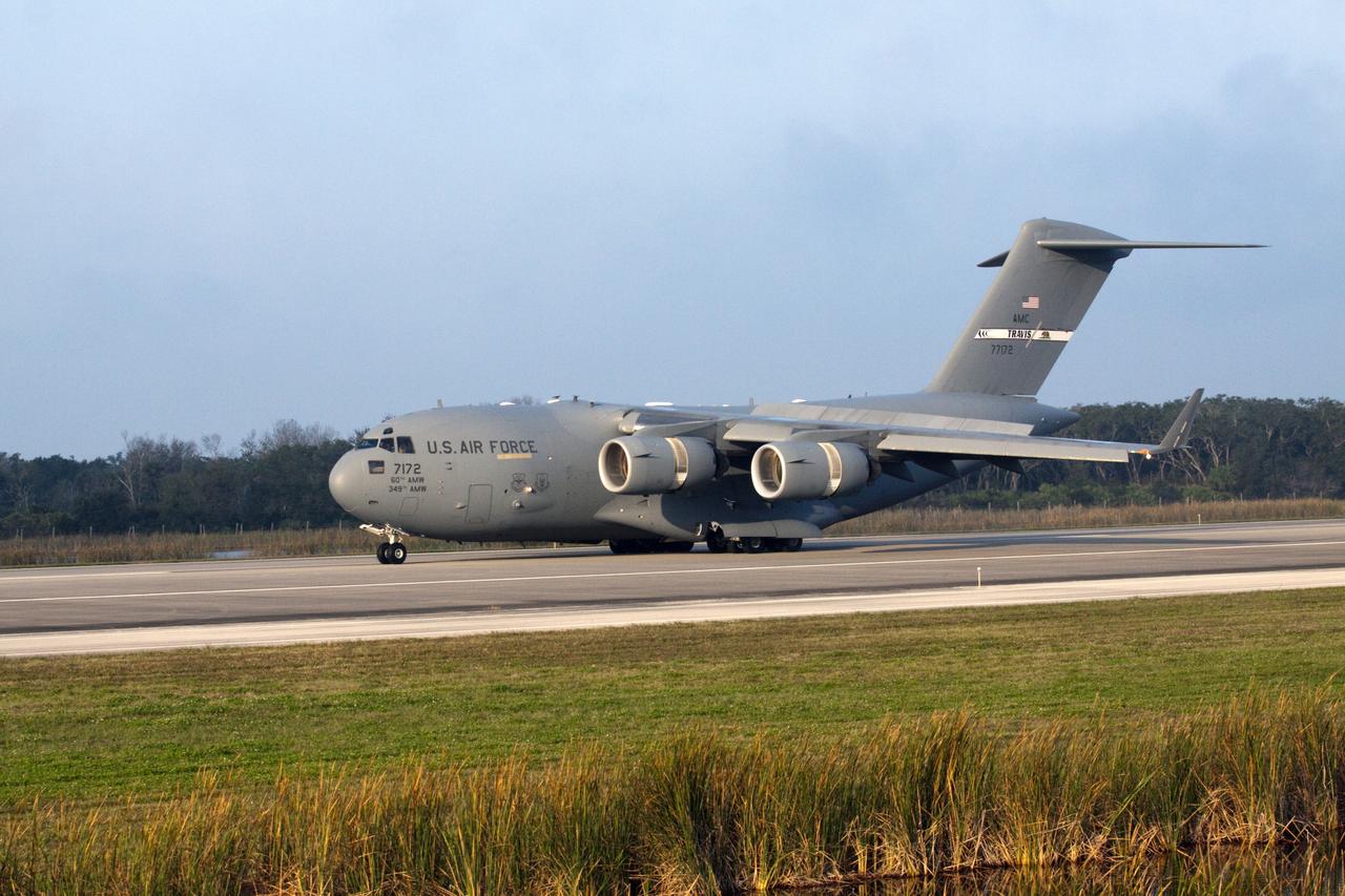 CAPE CANAVERAL, Fla. -- The Tracking and Data Relay Satellite known as TDRS-K arrives at NASA's Kennedy Space Center in Florida aboard an Air Force C-17 transport aircraft at 8:29 a.m. Dec. 18 at the agency's Kennedy Space Center in Florida in preparation for a Jan. 29 launch to a location in geostationary orbit. TDRS-K flew aboard a U.S. Air Force C-17 from the Boeing Space and Intelligence Systems assembly facility in El Segundo, Calif., for final preparation to launch aboard a United Launch Alliance Atlas V rocket. TDRS-K is the first of three next-generation satellites designed to ensure vital operational continuity for NASA by expanding the lifespan of the fleet. Each of the new satellites has a higher performance solar panel design to provide more spacecraft power. This upgrade will return signal processing for the S-Band multiple access service to the ground -- the same as the first-generation TDRS spacecraft. Ground-based processing allows TDRS to service more customers with different and evolving communication requirements. For more information, visit http://tdrs.gsfc.nasa.gov/ Photo credit: NASA/Kim Shiflett