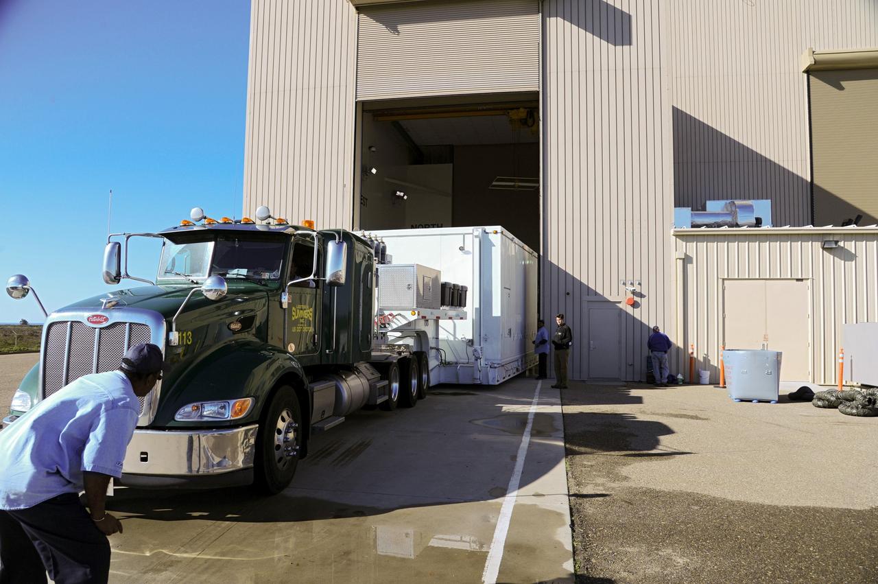 VANDENBERG AFB, Calif.-- The truck transporting NASA's Landsat Data Continuity Mission, or LDCM, satellite backs into the processing facility at Vandenberg Air Force Base, Calif. for prelaunch checkout.      The Landsat Data Continuity Mission LDCM is the future of Landsat satellites. It will continue to obtain valuable data and imagery to be used in agriculture, education, business, science, and government. The Landsat Program provides repetitive acquisition of high resolution multispectral data of the Earth's surface on a global basis. The data from the Landsat spacecraft constitute the longest record of the Earth's continental surfaces as seen from space. It is a record unmatched in quality, detail, coverage, and value. Launch is planned for Feb. 11, 2013. For more information, visit: http://www.nasa.gov/mission_pages/landsat/main/index.html Photo credit: NASA