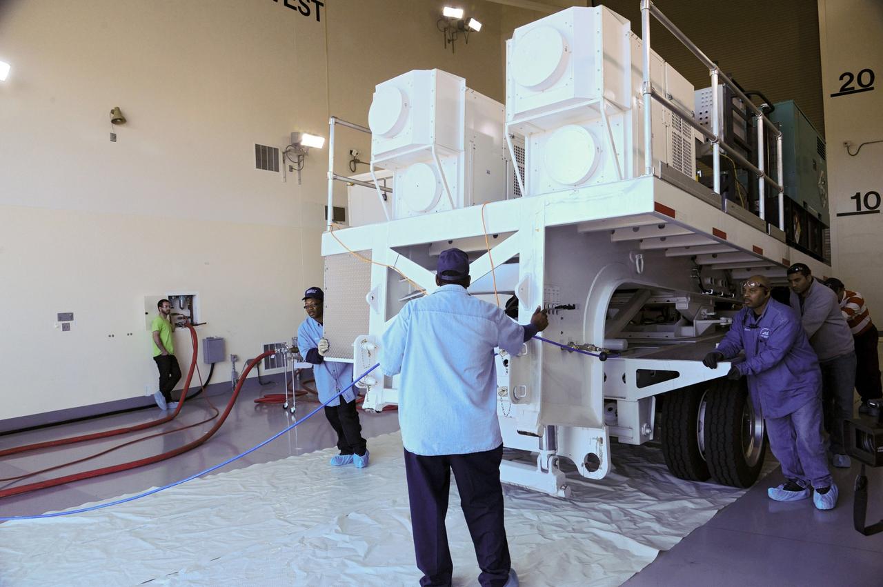 VANDENBERG AFB, Calif.-- The truck transporting NASA's Landsat Data Continuity Mission, or LDCM, satellite backs into the processing facility at Vandenberg Air Force Base, Calif. for prelaunch checkout.      The Landsat Data Continuity Mission LDCM is the future of Landsat satellites. It will continue to obtain valuable data and imagery to be used in agriculture, education, business, science, and government. The Landsat Program provides repetitive acquisition of high resolution multispectral data of the Earth's surface on a global basis. The data from the Landsat spacecraft constitute the longest record of the Earth's continental surfaces as seen from space. It is a record unmatched in quality, detail, coverage, and value. Launch is planned for Feb. 11, 2013. For more information, visit: http://www.nasa.gov/mission_pages/landsat/main/index.html Photo credit: NASA