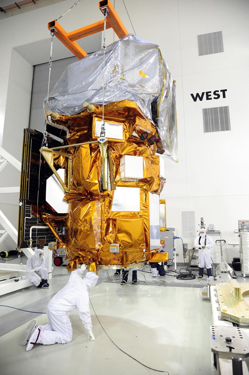 VANDENBERG AFB, Calif.-- Technicians use a crane to move NASA's Landsat Data Continuity Mission, or LDCM, satellite at the Astrotech processing facility at Vandenberg Air Force Base, Calif.      The Landsat Data Continuity Mission LDCM is the future of Landsat satellites. It will continue to obtain valuable data and imagery to be used in agriculture, education, business, science, and government. The Landsat Program provides repetitive acquisition of high resolution multispectral data of the Earth's surface on a global basis. The data from the Landsat spacecraft constitute the longest record of the Earth's continental surfaces as seen from space. It is a record unmatched in quality, detail, coverage, and value. Launch is planned for Feb. 11, 2013. For more information, visit: http://www.nasa.gov/mission_pages/landsat/main/index.html Photo credit: NASA