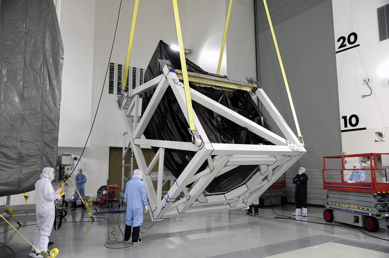 VANDENBERG AFB, Calif. -- Technicians unload and rotate NASA's Landsat Data Continuity Mission, or LDCM, satellite at the Astrotech processing facility at Vandenberg Air Force Base, Calif.      The Landsat Data Continuity Mission LDCM is the future of Landsat satellites. It will continue to obtain valuable data and imagery to be used in agriculture, education, business, science, and government. The Landsat Program provides repetitive acquisition of high resolution multispectral data of the Earth's surface on a global basis. The data from the Landsat spacecraft constitute the longest record of the Earth's continental surfaces as seen from space. It is a record unmatched in quality, detail, coverage, and value. Launch is planned for Feb. 11, 2013. For more information, visit: http://www.nasa.gov/mission_pages/landsat/main/index.html Photo credit: NASA