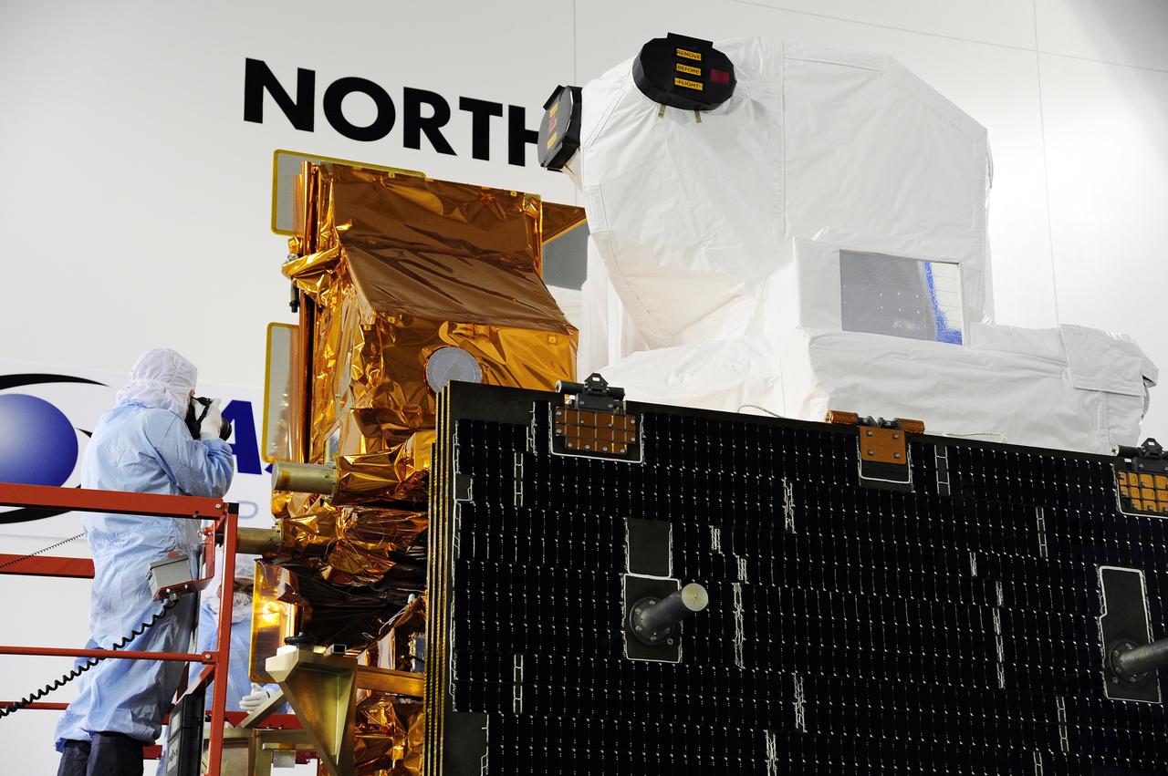 VANDENBERG AFB, Calif. -- A Technician photographs a component on NASA's Landsat Data Continuity Mission, or LDCM, satellite during inspection at the Astrotech processing facility at Vandenberg Air Force Base, Calif. The solar arrays are in the foreground.      The Landsat Data Continuity Mission LDCM is the future of Landsat satellites. It will continue to obtain valuable data and imagery to be used in agriculture, education, business, science, and government. The Landsat Program provides repetitive acquisition of high resolution multispectral data of the Earth's surface on a global basis. The data from the Landsat spacecraft constitute the longest record of the Earth's continental surfaces as seen from space. It is a record unmatched in quality, detail, coverage, and value. Launch is planned for Feb. 11, 2013. For more information, visit: http://www.nasa.gov/mission_pages/landsat/main/index.html Photo credit: NASA