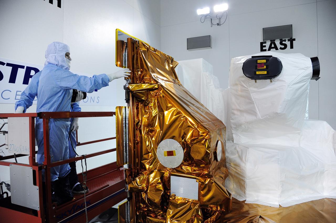VANDENBERG AFB, Calif. -- Technicians inspect NASA's Landsat Data Continuity Mission, or LDCM, satellite at the Astrotech processing facility at Vandenberg Air Force Base, Calif.      The Landsat Data Continuity Mission LDCM is the future of Landsat satellites. It will continue to obtain valuable data and imagery to be used in agriculture, education, business, science, and government. The Landsat Program provides repetitive acquisition of high resolution multispectral data of the Earth's surface on a global basis. The data from the Landsat spacecraft constitute the longest record of the Earth's continental surfaces as seen from space. It is a record unmatched in quality, detail, coverage, and value. Launch is planned for Feb. 11, 2013. For more information, visit: http://www.nasa.gov/mission_pages/landsat/main/index.html Photo credit: NASA