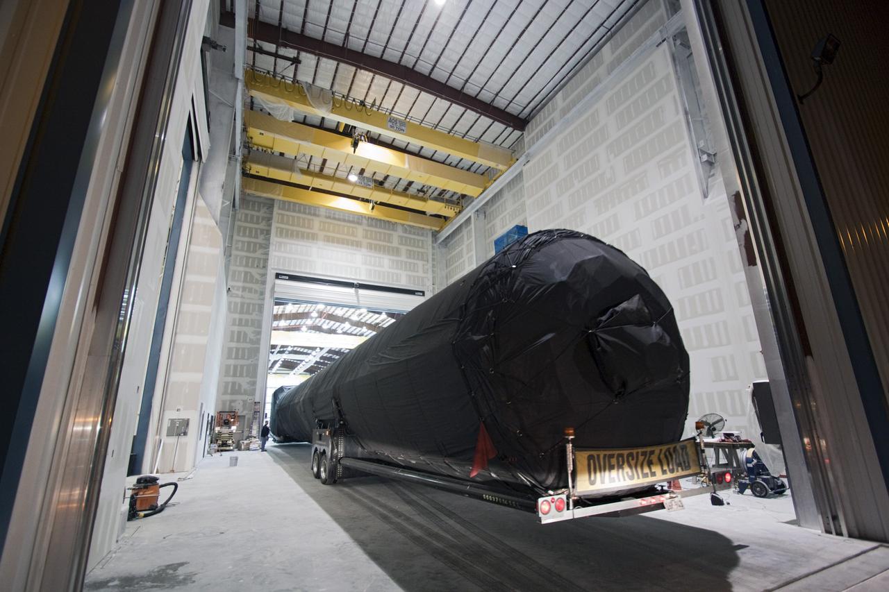 CAPE CANAVERAL, Fla. – A truck pulls the first stage of the Falcon 9 rocket inside the SpaceX Falcon Hangar at Launch Complex 40 on Cape Canaveral Air Force Station in Florida.     The two-stage rocket will launch the company's Dragon spacecraft on the upcoming SpaceX CRS-2 mission. The flight will be the second commercial resupply mission to the International Space Station by Space Exploration Technologies, or SpaceX. NASA has contracted for a total of 12 commercial resupply flights from SpaceX and eight from the Orbital Sciences Corp. Photo credit: NASA/Jim Grossmann