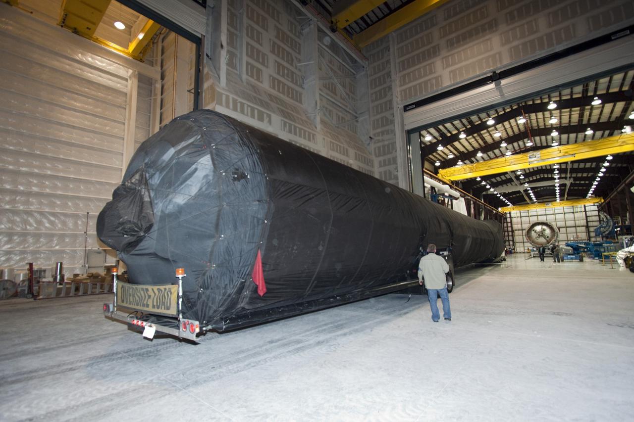 CAPE CANAVERAL, Fla. – A truck pulls the first stage of the Falcon 9 rocket inside the SpaceX Falcon Hangar at Launch Complex 40 on Cape Canaveral Air Force Station in Florida.      The two-stage rocket will launch the company's Dragon spacecraft on the upcoming SpaceX-2 mission. SpaceX-2 will be the second commercial resupply mission to the International Space Station by Space Exploration Technologies SpaceX. NASA has contracted for a total of 12 commercial resupply flights from SpaceX and eight from the Orbital Sciences Corp. Photo credit: NASA/Jim Grossmann