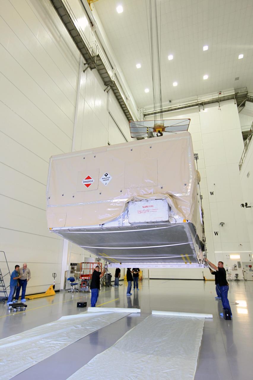TITUSVILLE, Fla. - Technicians use a crane to lift the transport container with the Tracking and Data Relay Satellite, TDRS-K, after arrival at the Astrotech payload processing facility in Titusville, Fla. near NASA’s Kennedy Space Center.      Launch of the TDRS-K on the Atlas V rocket is planned for January 29, 2013. The TDRS-K spacecraft is part of the next-generation series in the Tracking and Data Relay Satellite System, a constellation of space-based communication satellites providing tracking, telemetry, command and high-bandwidth data return services. For more information, visit http://www.nasa.gov/mission_pages/tdrs/index.html Photo credit: NASA/Kim Shiflett