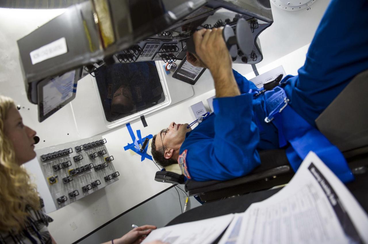 HOUSTON -- NASA Astronaut Lee Archambault performs an evaluation of reach and visibility of controls and displays during an end-of-year interior layout evaluation of The Boeing Company's CST-100 spacecraft. The evaluation at Boeing's Houston Product Support Center in Texas was part of the company's ongoing work supporting its funded Space Act Agreement with NASA's Commercial Crew Program, or CCP, during the Commercial Crew Integrated Capability, or CCiCap, initiative.      CCP is intended to lead to the availability of commercial human spaceflight services for government and commercial customers to low-Earth orbit. Future development and certification initiatives eventually will lead to the availability of human spaceflight services for NASA to send its astronauts to the International Space Station, where critical research is taking place daily. For more information about CCP, go to http://www.nasa.gov/commercialcrew. Photo credit: Boeing
