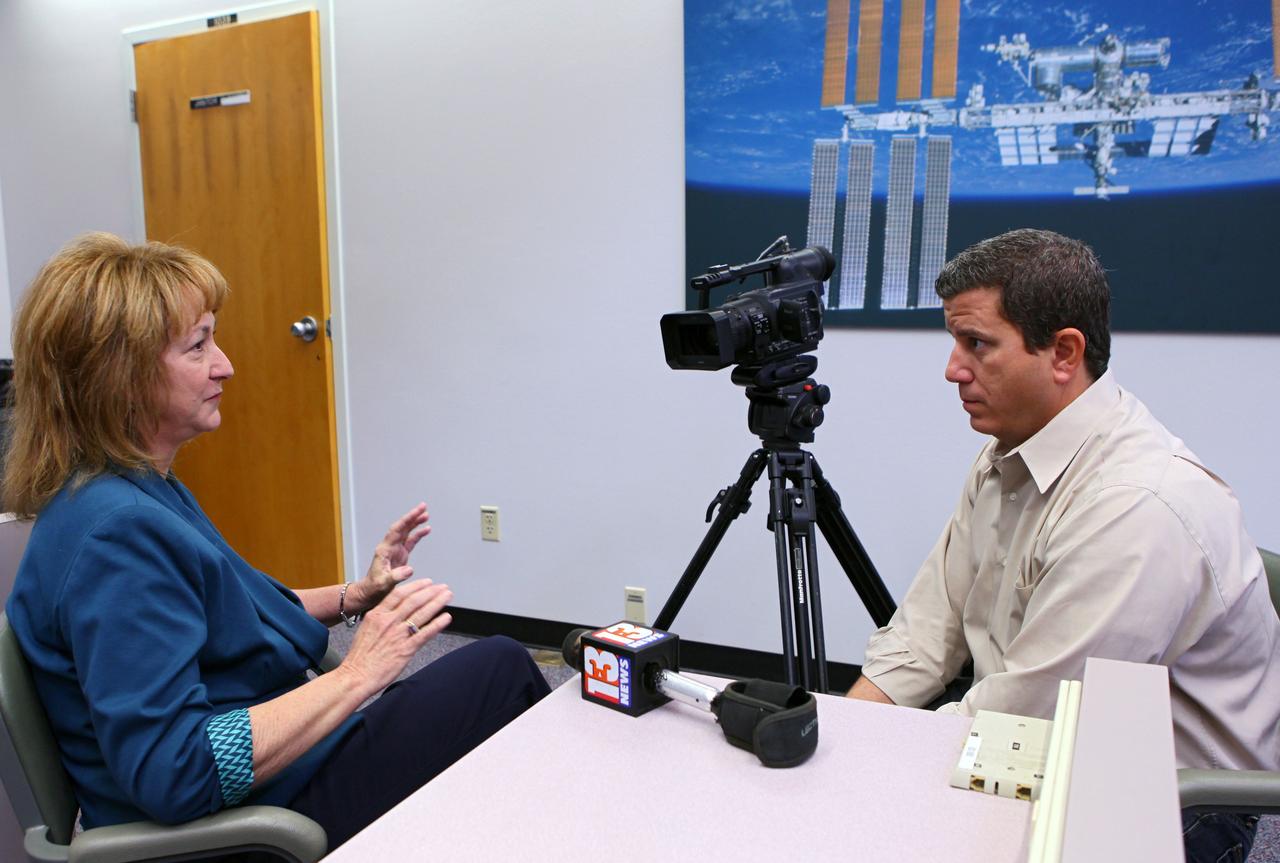 CAPE CANAVERAL, Fla. -- To start the new year, Joyce M. Riquelme from Kennedy's Center Planning and Development Office discusses the space center's direction with TV news reporter Greg Pallone of Channel 13 in Orlando.The office's purpose is to develop the world’s premier spaceport, meeting government and commercial space industry needs through comprehensive resource planning and the formation of partnerships to ensure the economic vitality of Kennedy Space Center. Photo credit: NASA/Kim Shiflett