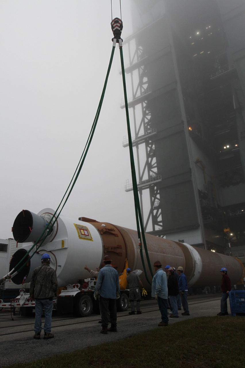 CAPE CANAVERAL, Fla. -- In the morning fog at Cape Canaveral Air Force Station's Space Launch Complex 41 in Florida, preparations are underway to erect the first stage of the Atlas V rocket that will carry the Tracking and Data Relay Satellite, TDRS-K, into orbit.      Launch of the TDRS-K on the Atlas V rocket is planned for January 29, 2013. The TDRS-K spacecraft is part of the next-generation series in the Tracking and Data Relay Satellite System, a constellation of space-based communication satellites providing tracking, telemetry, command and high-bandwidth data return services. For more information, visit http://www.nasa.gov/mission_pages/tdrs/index.html Photo credit: NASA/ Ben Smegelsky
