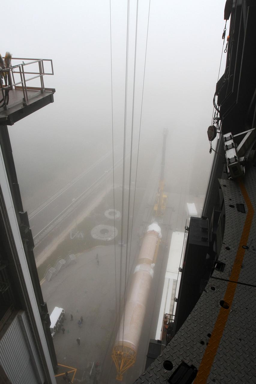 CAPE CANAVERAL, Fla. -- In the morning fog at Cape Canaveral Air Force Station's Space Launch Complex 41 in Florida, operations are underway to erect the first stage of the Atlas V rocket that will carry the Tracking and Data Relay Satellite, TDRS-K, into orbit.      Launch of the TDRS-K on the Atlas V rocket is planned for January 29, 2013. The TDRS-K spacecraft is part of the next-generation series in the Tracking and Data Relay Satellite System, a constellation of space-based communication satellites providing tracking, telemetry, command and high-bandwidth data return services. For more information, visit http://www.nasa.gov/mission_pages/tdrs/index.html Photo credit: NASA/ Ben Smegelsky