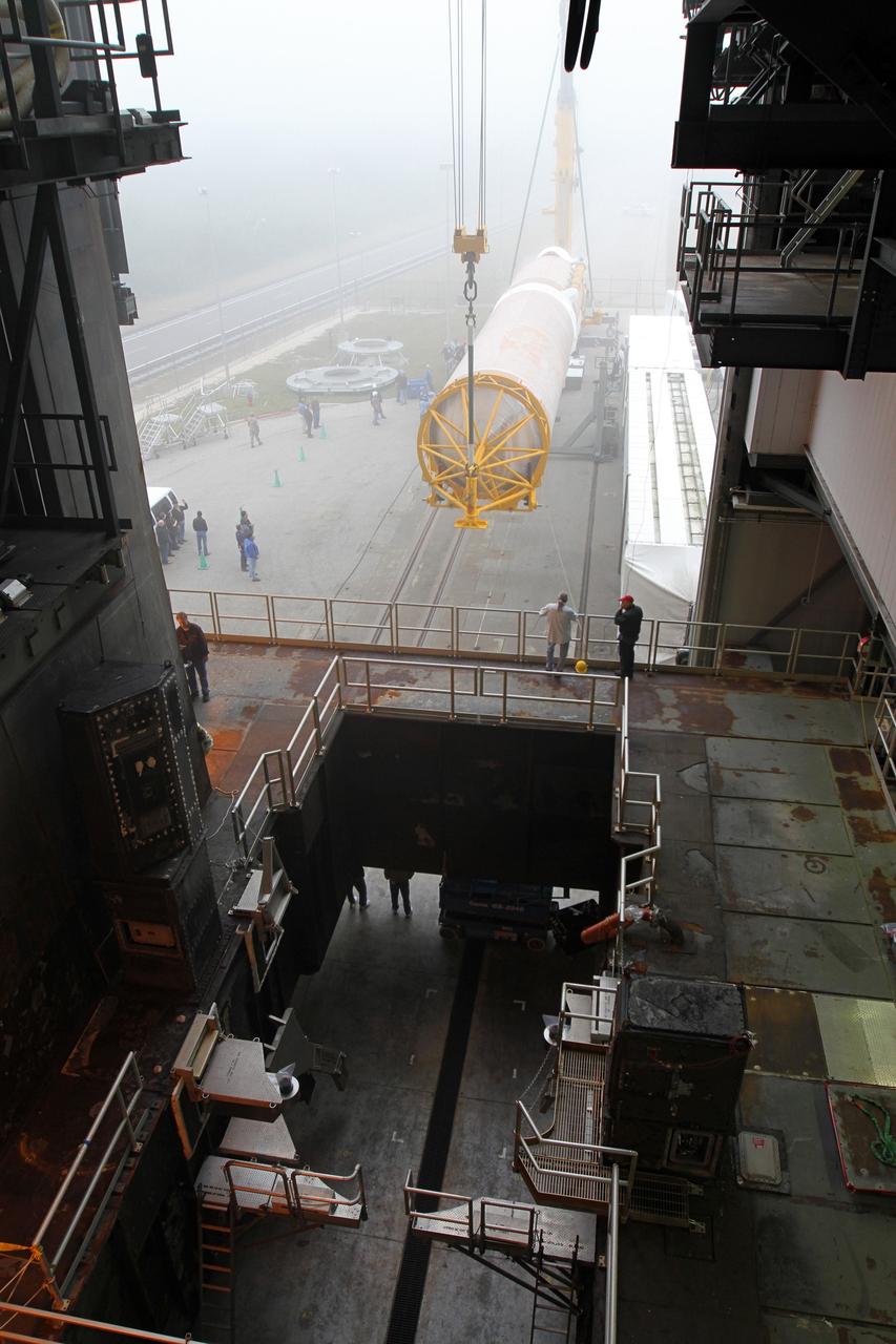CAPE CANAVERAL, Fla. -- In the morning fog at Cape Canaveral Air Force Station's Space Launch Complex 41 in Florida, operations are underway to erect the first stage of the Atlas V rocket that will carry the Tracking and Data Relay Satellite, TDRS-K, into orbit.      Launch of the TDRS-K on the Atlas V rocket is planned for January 29, 2013. The TDRS-K spacecraft is part of the next-generation series in the Tracking and Data Relay Satellite System, a constellation of space-based communication satellites providing tracking, telemetry, command and high-bandwidth data return services. For more information, visit http://www.nasa.gov/mission_pages/tdrs/index.html Photo credit: NASA/ Ben Smegelsky
