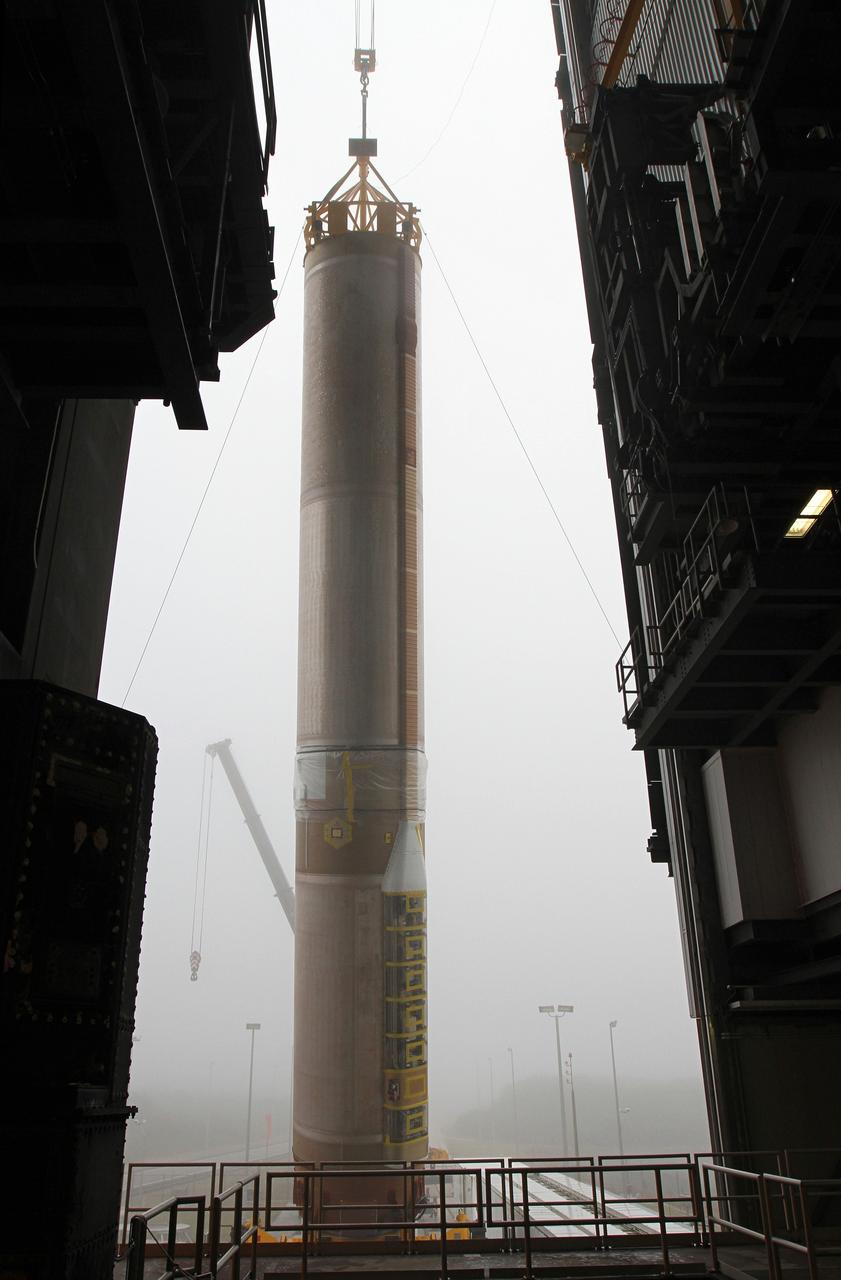 CAPE CANAVERAL, Fla. -- In the morning fog at Cape Canaveral Air Force Station's Space Launch Complex 41 in Florida, operations are underway to erect the first stage of the Atlas V rocket that will carry the Tracking and Data Relay Satellite, TDRS-K, into orbit.      Launch of the TDRS-K on the Atlas V rocket is planned for January 29, 2013. The TDRS-K spacecraft is part of the next-generation series in the Tracking and Data Relay Satellite System, a constellation of space-based communication satellites providing tracking, telemetry, command and high-bandwidth data return services. For more information, visit http://www.nasa.gov/mission_pages/tdrs/index.html Photo credit: NASA/ Ben Smegelsky