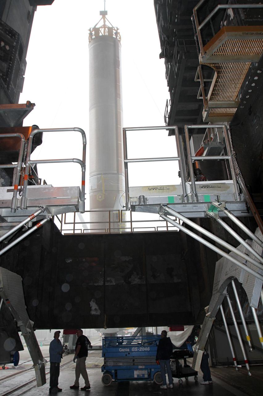 CAPE CANAVERAL, Fla. -- In the morning fog at Cape Canaveral Air Force Station's Space Launch Complex 41 in Florida, United Launch Alliance technicians support operations to erect the first stage of the Atlas V rocket that will carry the Tracking and Data Relay Satellite, TDRS-K, into orbit.      Launch of the TDRS-K on the Atlas V rocket is planned for January 29, 2013. The TDRS-K spacecraft is part of the next-generation series in the Tracking and Data Relay Satellite System, a constellation of space-based communication satellites providing tracking, telemetry, command and high-bandwidth data return services. For more information, visit http://www.nasa.gov/mission_pages/tdrs/index.html Photo credit: NASA/ Ben Smegelsky