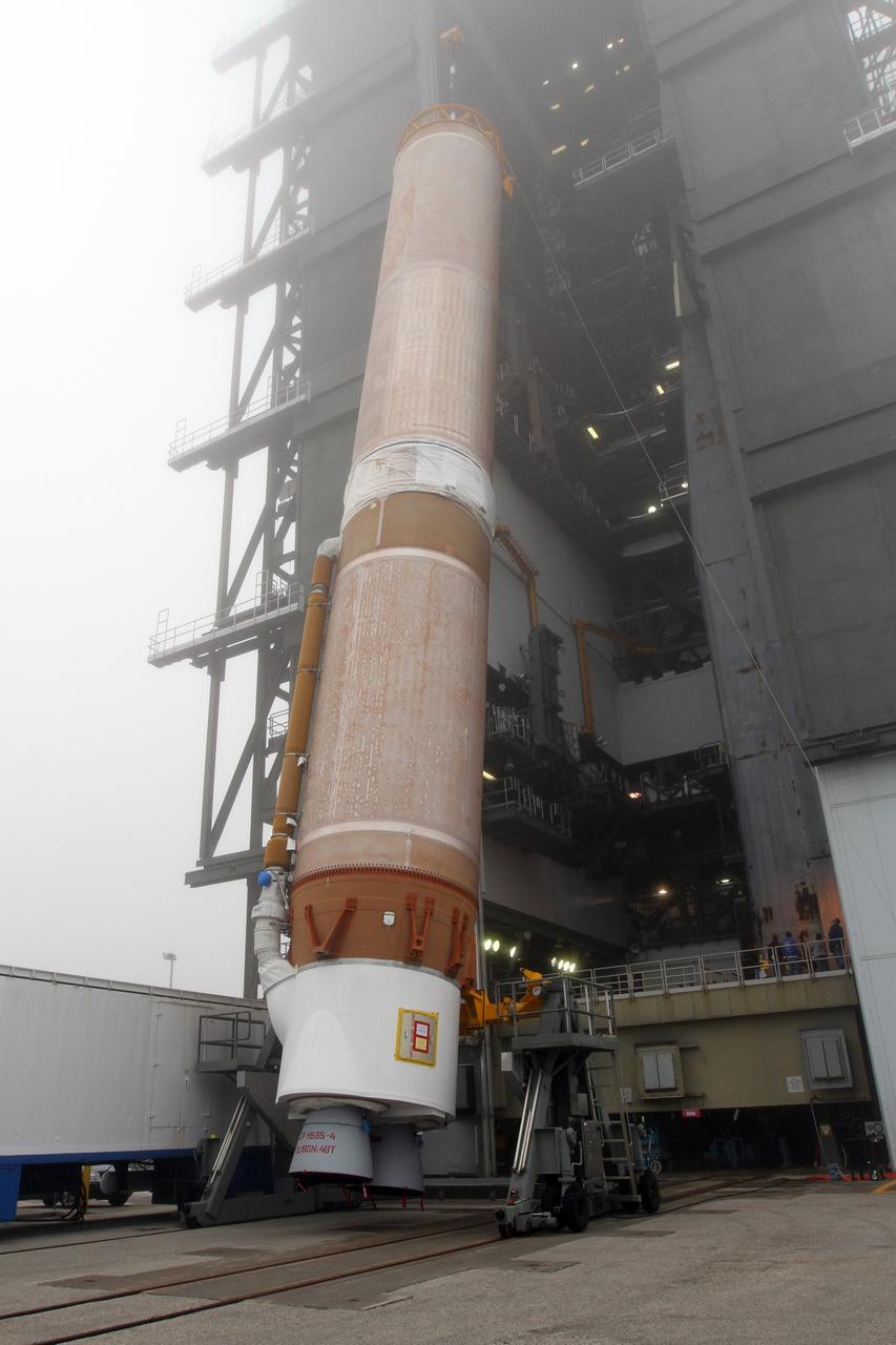 CAPE CANAVERAL, Fla. -- In the morning fog at Cape Canaveral Air Force Station's Space Launch Complex 41 in Florida, operations are underway to erect the first stage of the Atlas V rocket that will carry the Tracking and Data Relay Satellite, TDRS-K, into orbit.      Launch of the TDRS-K on the Atlas V rocket is planned for January 29, 2013. The TDRS-K spacecraft is part of the next-generation series in the Tracking and Data Relay Satellite System, a constellation of space-based communication satellites providing tracking, telemetry, command and high-bandwidth data return services. For more information, visit http://www.nasa.gov/mission_pages/tdrs/index.html Photo credit: NASA/ Ben Smegelsky