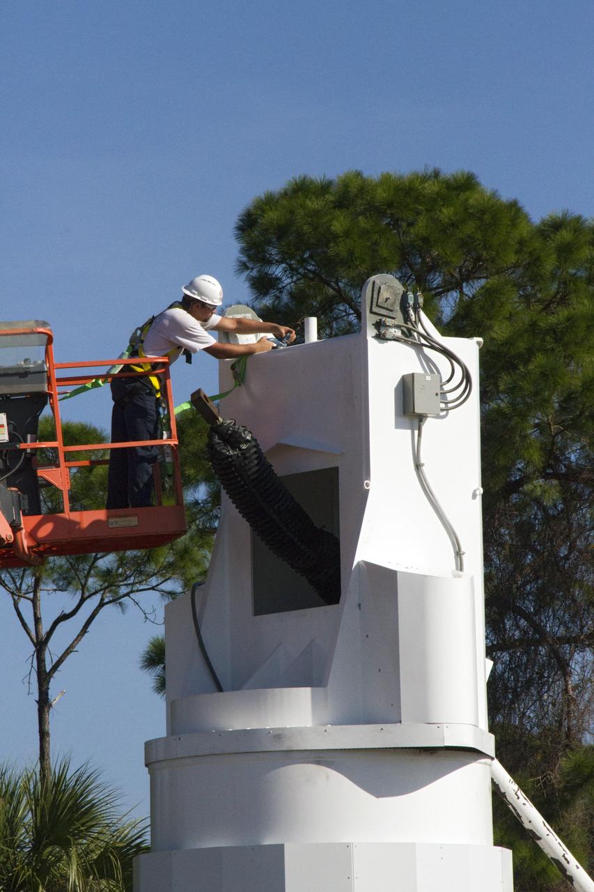 CAPE CANAVERAL, Fla. – At NASA’s Kennedy Space Center in Florida, a worker makes adjustments on a new tower being constructed for the Antenna Test Bed Array for the Ka-Band Objects Observation and Monitoring, or Ka-BOOM system. The antennas will be part of the operations command center facility. The construction site is near the former Vertical Processing Facility, which has been demolished. The Ka-BOOM project is one of the final steps in developing the techniques to build a high power, high resolution radar system capable of becoming a Near Earth Object Early Warning System. While also capable of space communication and radio science experiments, developing radar applications is the primary focus of the arrays. Photo credit: NASA/ Ben Smegelsky