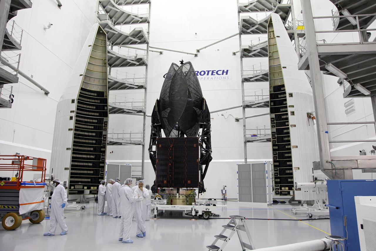 TITUSVILLE, Fla. – NASA's Tracking and Data Relay Satellite, TDRS-K, stands positioned between two pieces that make up the payload fairing that will protect the spacecraft during launch and ascent into space. Technicians working inside the Astrotech payload processing facility in Titusville, Fla., near NASA’s Kennedy Space Center will perform the encapsulation. Launch of the TDRS-K on the United Launch Alliance Atlas V rocket is planned for January 29, 2013. The TDRS-K spacecraft is part of the next-generation series in the Tracking and Data Relay Satellite System, a constellation of space-based communication satellites providing tracking, telemetry, command and high-bandwidth data return services. Photo credit: NASA/Frankie Martin