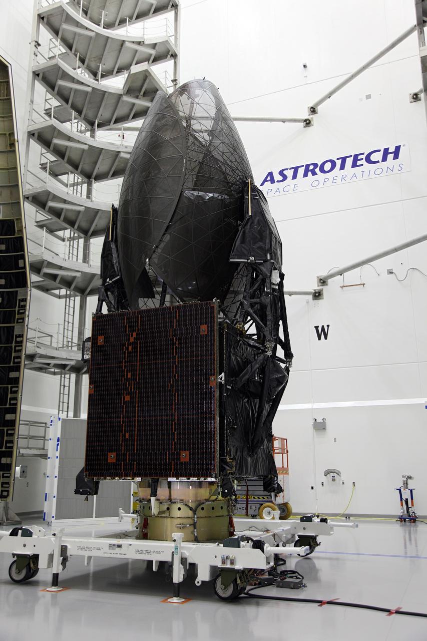 TITUSVILLE, Fla. - NASA's Tracking and Data Relay Satellite, TDRS-K, stands positioned between two pieces that make up the payload fairing that will protect the spacecraft during launch and ascent into space. Technicians working inside the Astrotech payload processing facility in Titusville, Fla., near NASA’s Kennedy Space Center will perform the encapsulation. Launch of the TDRS-K on the United Launch Alliance Atlas V rocket is planned for January 29, 2013. The TDRS-K spacecraft is part of the next-generation series in the Tracking and Data Relay Satellite System, a constellation of space-based communication satellites providing tracking, telemetry, command and high-bandwidth data return services. Photo credit: NASA/Frankie Martin