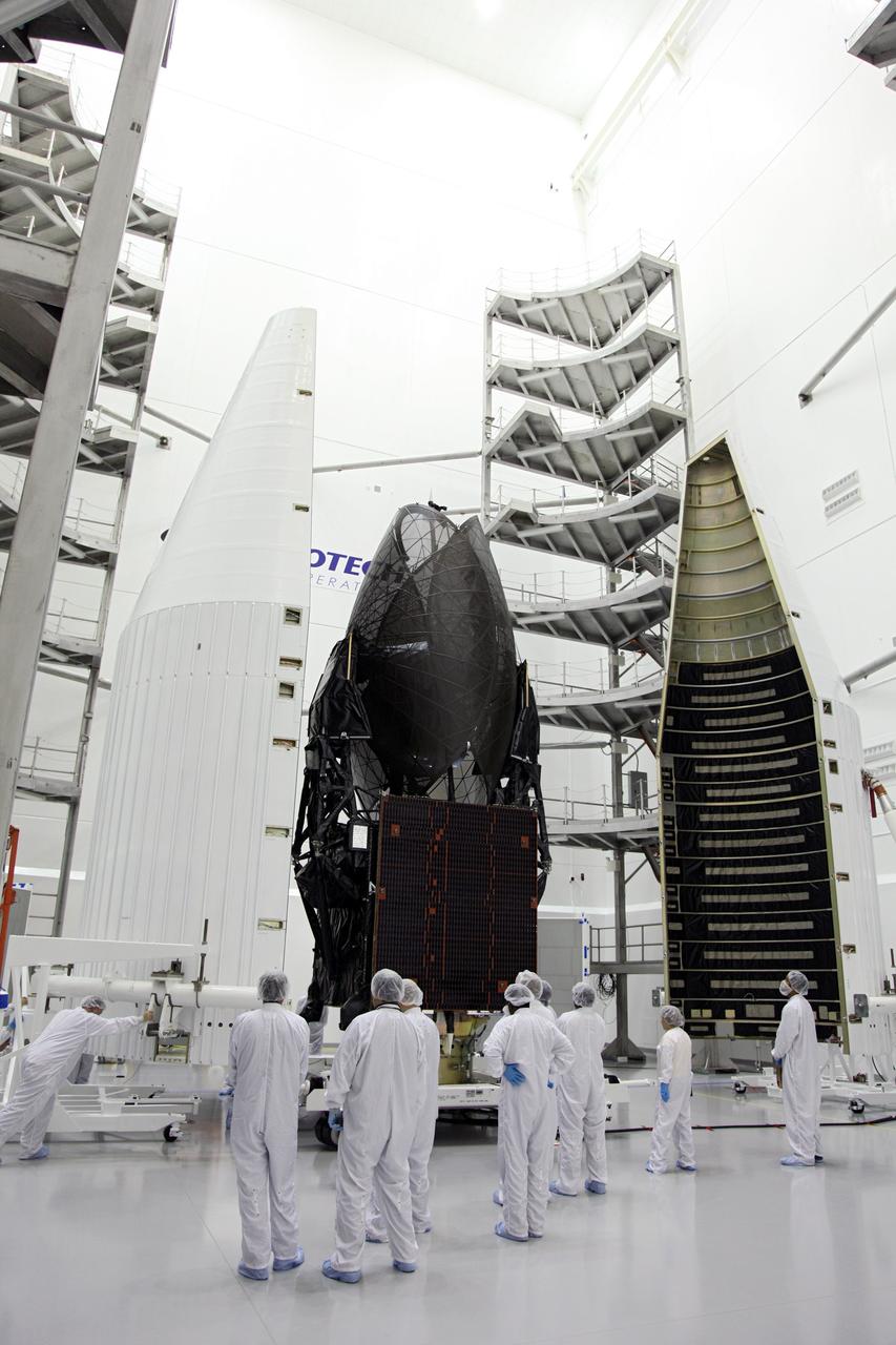 TITUSVILLE, Fla. - NASA's Tracking and Data Relay Satellite, TDRS-K, stands positioned between two pieces that make up the payload fairing that will protect the spacecraft during launch and ascent into space. Technicians working inside the Astrotech payload processing facility in Titusville, Fla., near NASA’s Kennedy Space Center will perform the encapsulation. Launch of the TDRS-K on the United Launch Alliance Atlas V rocket is planned for January 29, 2013. The TDRS-K spacecraft is part of the next-generation series in the Tracking and Data Relay Satellite System, a constellation of space-based communication satellites providing tracking, telemetry, command and high-bandwidth data return services. Photo credit: NASA/Frankie Martin