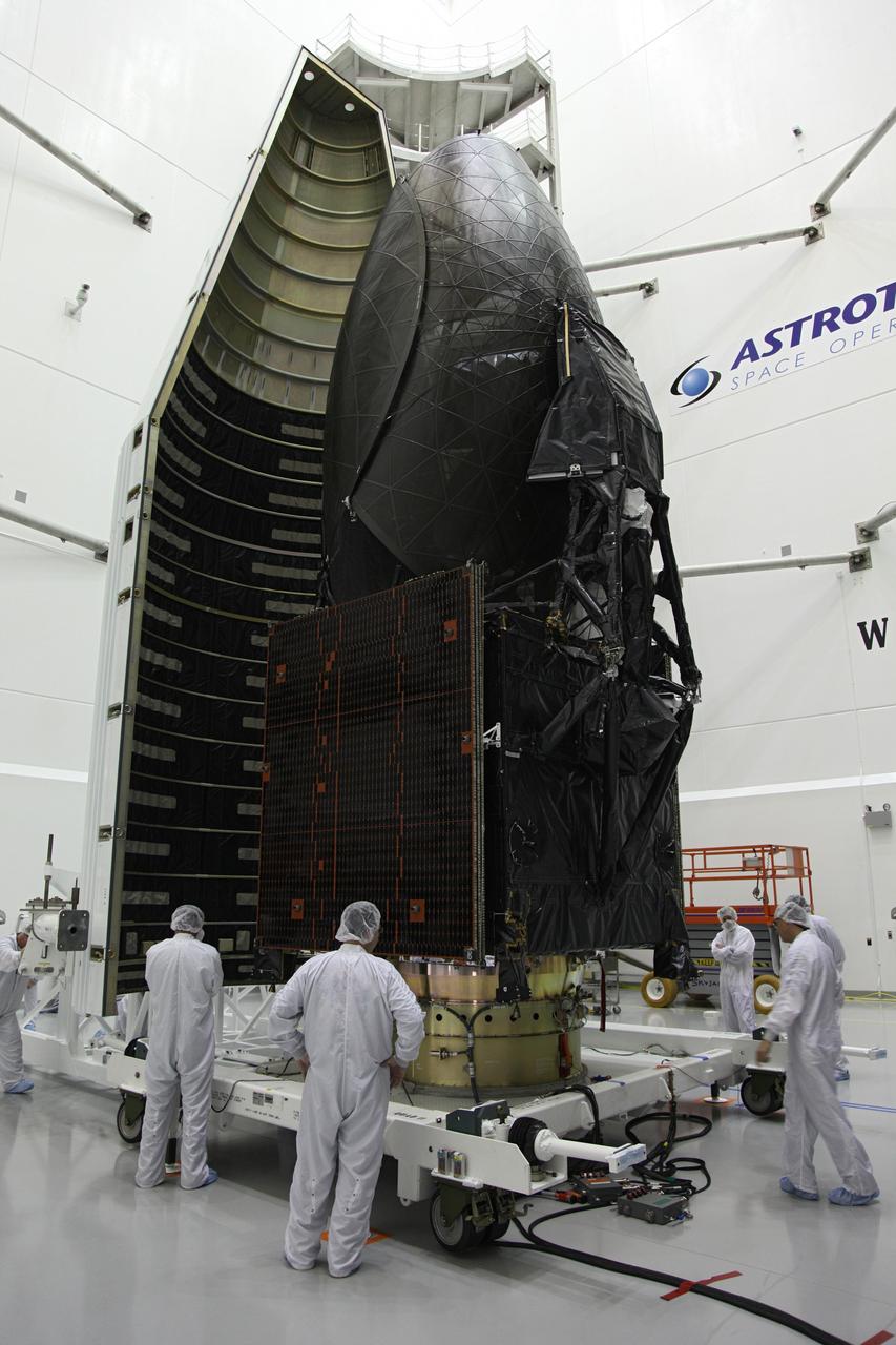 TITUSVILLE, Fla. – Technicians move one half of the payload fairing into place over NASA's Tracking and Data Relay Satellite, TDRS-K, inside the Astrotech payload processing facility in Titusville, Fla., near NASA’s Kennedy Space Center. Launch of the TDRS-K on a United Launch Alliance Atlas V rocket is planned for January 29, 2013. The TDRS-K spacecraft is part of the next-generation series in the Tracking and Data Relay Satellite System, a constellation of space-based communication satellites providing tracking, telemetry, command and high-bandwidth data return services. Photo credit: NASA/Frankie Martin