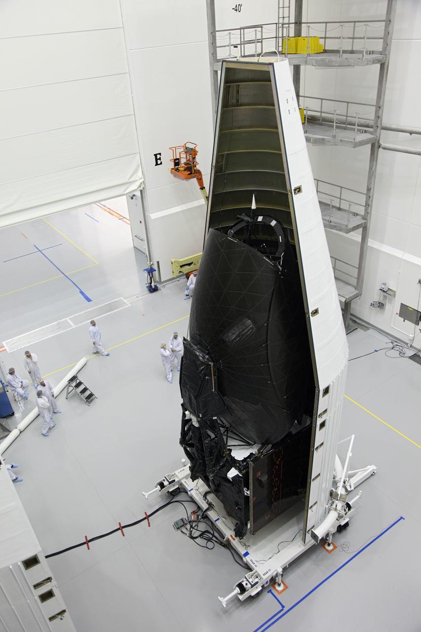 TITUSVILLE, Fla. – NASA's Tracking and Data Relay Satellite, TDRS-K, stands inside one half of the payload fairing as the spacecraft is encapsulated inside a United Launch Alliance Astrotech payload processing facility in Titusville, Fla., near NASA’s Kennedy Space Center. Launch of the TDRS-K on the Atlas V rocket is planned for January 29, 2013. The TDRS-K spacecraft is part of the next-generation series in the Tracking and Data Relay Satellite System, a constellation of space-based communication satellites providing tracking, telemetry, command and high-bandwidth data return services. Photo credit: NASA/Frankie Martin