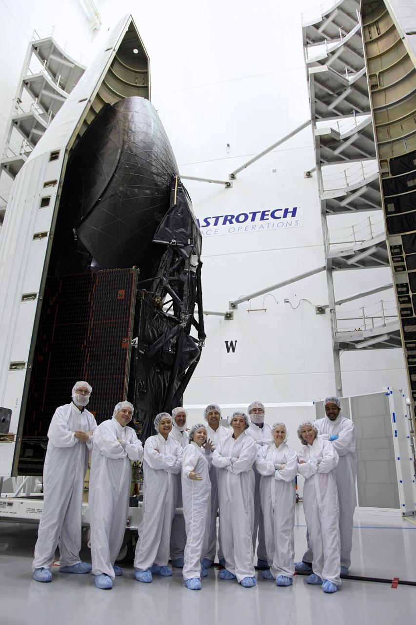 TITUSVILLE, Fla. – Technicians who moved one half of the payload fairing into place over NASA's Tracking and Data Relay Satellite, TDRS-K, pose inside the Astrotech payload processing facility in Titusville, Fla., near NASA’s Kennedy Space Center. Launch of the TDRS-K on a United Launch Alliance Atlas V rocket is planned for January 29, 2013. The TDRS-K spacecraft is part of the next-generation series in the Tracking and Data Relay Satellite System, a constellation of space-based communication satellites providing tracking, telemetry, command and high-bandwidth data return services. Photo credit: NASA/Frankie Martin