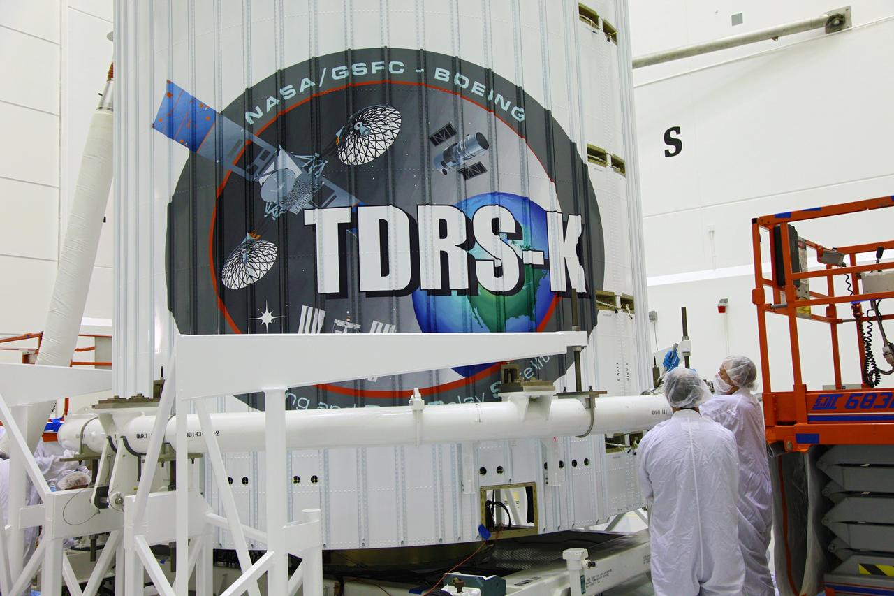 TITUSVILLE, Fla. – Technicians inspect the payload fairing placed over NASA's Tracking and Data Relay Satellite, TDRS-K, inside the Astrotech payload processing facility in Titusville, Fla., near NASA’s Kennedy Space Center. Launch of the TDRS-K on a United Launch Alliance Atlas V rocket is planned for January 29, 2013. The TDRS-K spacecraft is part of the next-generation series in the Tracking and Data Relay Satellite System, a constellation of space-based communication satellites providing tracking, telemetry, command and high-bandwidth data return services. Photo credit: NASA/Tim Jacobs
