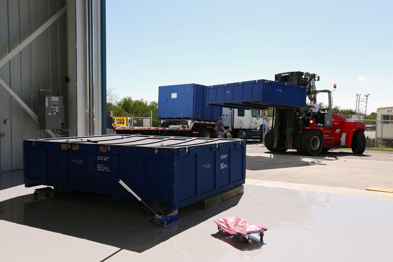 CAPE CANAVERAL, Fla. – A forklift moves containers from a truck at the processing hangar used by Space Exploration Technologies, or SpaceX, at Cape Canaveral Air Force Station, Fla. The truck is carrying solar array fairings to be installed on the Dragon spacecraft undergoing launch preparations inside the hangar. The spacecraft will launch on the upcoming SpaceX CRS-2 mission. The flight will be the second commercial resupply mission to the International Space Station by SpaceX. NASA has contracted for a total of 12 commercial resupply flights from SpaceX and eight from the Orbital Sciences Corp. Photo credit: NASA/Kim Shiflett