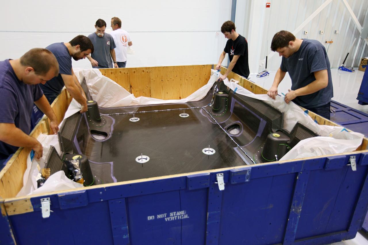 CAPE CANAVERAL, Fla. – Workers inspect a solar array fairing at the processing hangar used by Space Exploration Technologies, or SpaceX, at Cape Canaveral Air Force Station, Fla. The fairings are to be installed on the Dragon spacecraft undergoing launch preparations inside the hangar. The spacecraft will launch on the upcoming SpaceX CRS-2 mission. The flight will be the second commercial resupply mission to the International Space Station by SpaceX. NASA has contracted for a total of 12 commercial resupply flights from SpaceX and eight from the Orbital Sciences Corp. Photo credit: NASA/Kim Shiflett
