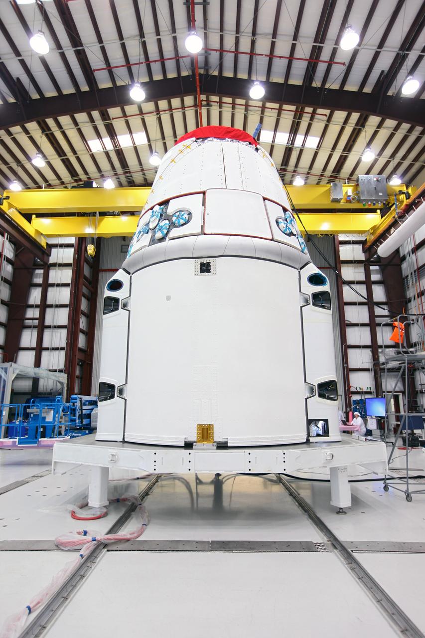 CAPE CANAVERAL, Fla. – The Space Exploration Technologies, or SpaceX, Dragon spacecraft with solar array fairings attached, stands inside a processing hangar at Cape Canaveral Air Force Station, Fla. The spacecraft will launch on the upcoming SpaceX CRS-2 mission. The flight will be the second commercial resupply mission to the International Space Station by SpaceX. NASA has contracted for a total of 12 commercial resupply flights from SpaceX and eight from the Orbital Sciences Corp. Photo credit: NASA/Kim Shiflett