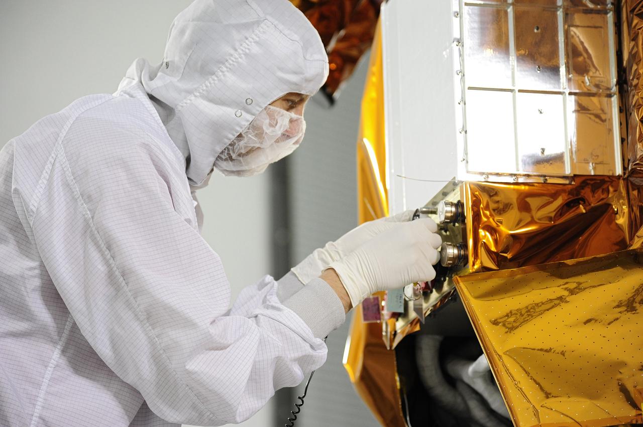 VANDENBERG AFB, Calif. – Technicians perform thermal blanket closeouts on the fuel servicing valves on the Landsat Data Continuity Mission, or LDCM, spacecraft in the Astrotech processing facility at Vandenberg Air Force Base in Calif., following fueling operations. The Landsat Data Continuity Mission is the future of Landsat satellites. It will continue to obtain valuable data and imagery to be used in agriculture, education, business, science, and government. The Landsat Program provides repetitive acquisition of high resolution multispectral data of the Earth's surface on a global basis. The data from the Landsat spacecraft constitute the longest record of the Earth's continental surfaces as seen from space. It is a record unmatched in quality, detail, coverage, and value. Launch is planned for Feb. 11, 2013. For more information, visit: http://www.nasa.gov/mission_pages/landsat/main/index.html Photo credit: VAFB