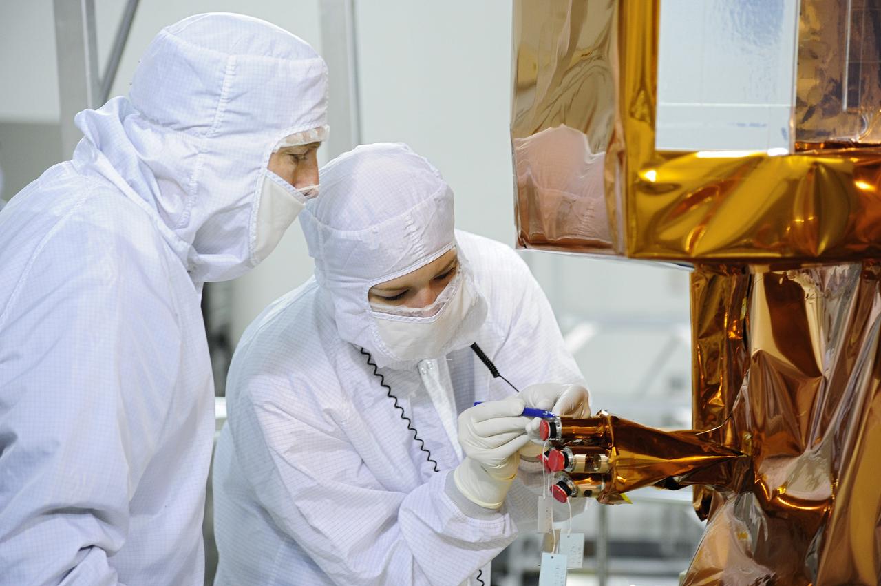VANDENBERG AFB, Calif. – A technician inspects the Landsat Data Continuity Mission, or LDCM, spacecraft in the Astrotech processing facility at Vandenberg Air Force Base in Calif., following fueling operations. The Landsat Data Continuity Mission is the future of Landsat satellites. It will continue to obtain valuable data and imagery to be used in agriculture, education, business, science, and government. The Landsat Program provides repetitive acquisition of high resolution multispectral data of the Earth's surface on a global basis. The data from the Landsat spacecraft constitute the longest record of the Earth's continental surfaces as seen from space. It is a record unmatched in quality, detail, coverage, and value. Launch is planned for Feb. 11, 2013. For more information, visit: http://www.nasa.gov/mission_pages/landsat/main/index.html Photo credit: VAFB