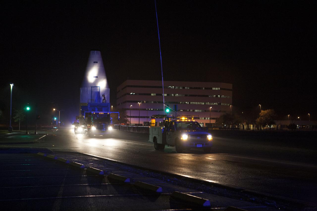 CAPE CANAVERAL, Fla. –NASA's Tracking and Data Relay Satellite, TDRS-K, enclosed in its payload fairing, passes through the Launch Complex 39 area and Operations Support Building at NASA's Kennedy Space Center as it travels from the Astrotech payload processing facility in Titusville, Fla., to its launch site. TDRS-K will lift off atop a United Launch Alliance Atlas V rocket from Cape Canaveral Air Force Station's Space Launch Complex 41. The TDRS-K spacecraft is part of the next-generation series in the Tracking and Data Relay Satellite System, a constellation of space-based communication satellites providing tracking, telemetry, command and high-bandwidth data return services. For more information, go to http://www.nasa.gov/tdrs Photo credit: NASA/Glenn Benson