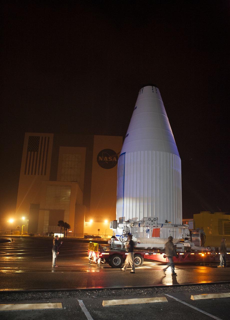 CAPE CANAVERAL, Fla. –NASA's Tracking and Data Relay Satellite, TDRS-K, enclosed in its payload fairing, passes through the Launch Complex 39 area and Vehicle Assembly Building at NASA's Kennedy Space Center as it travels from the Astrotech payload processing facility in Titusville, Fla., to its launch site. TDRS-K will lift off atop a United Launch Alliance Atlas V rocket from Cape Canaveral Air Force Station's Space Launch Complex 41. The TDRS-K spacecraft is part of the next-generation series in the Tracking and Data Relay Satellite System, a constellation of space-based communication satellites providing tracking, telemetry, command and high-bandwidth data return services. For more information, go to http://www.nasa.gov/tdrs Photo credit: NASA/Glenn Benson