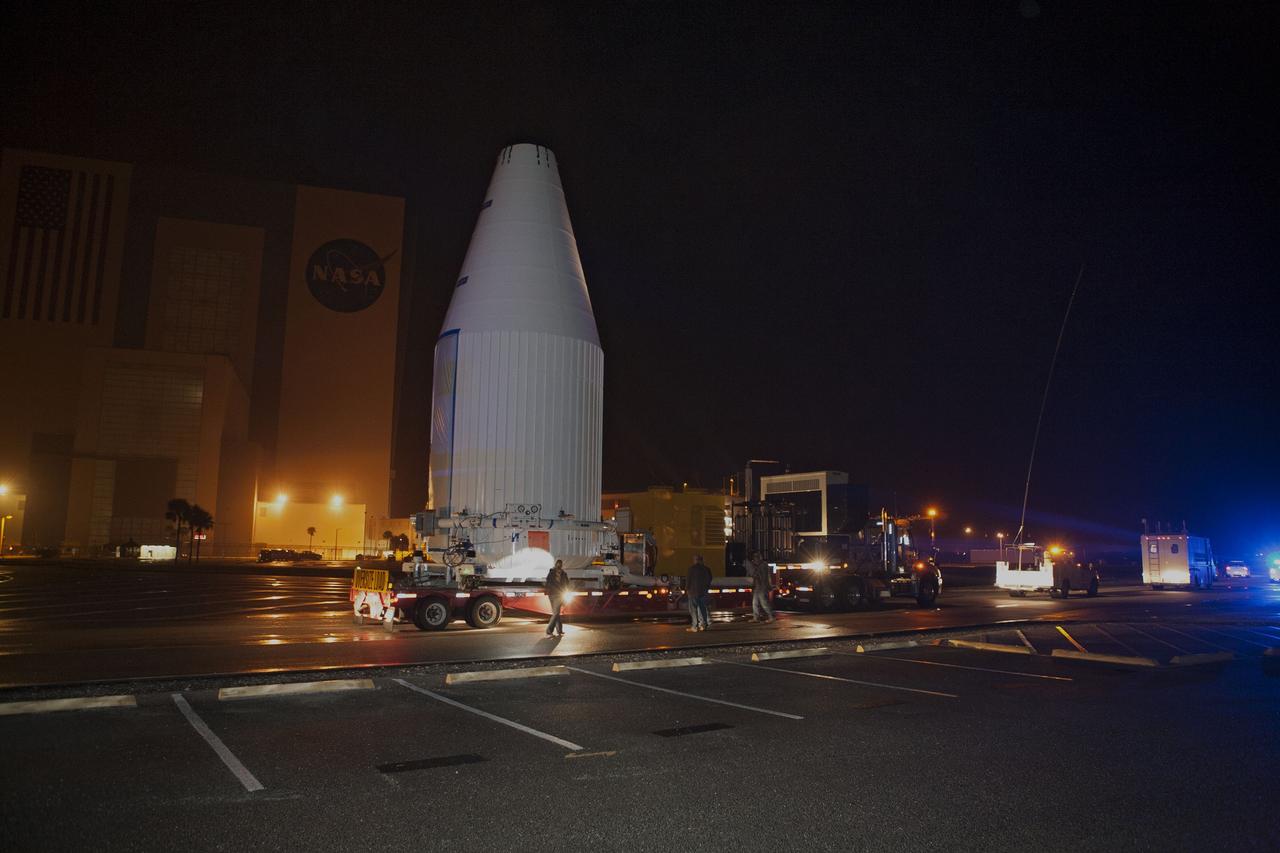 CAPE CANAVERAL, Fla. –NASA's Tracking and Data Relay Satellite, TDRS-K, enclosed in its payload fairing, passes through the Launch Complex 39 area and Vehicle Assembly Building at NASA's Kennedy Space Center as it travels from the Astrotech payload processing facility in Titusville, Fla., to its launch site. TDRS-K will lift off atop a United Launch Alliance Atlas V rocket from Cape Canaveral Air Force Station's Space Launch Complex 41. The TDRS-K spacecraft is part of the next-generation series in the Tracking and Data Relay Satellite System, a constellation of space-based communication satellites providing tracking, telemetry, command and high-bandwidth data return services. For more information, go to http://www.nasa.gov/tdrs Photo credit: NASA/Glenn Benson