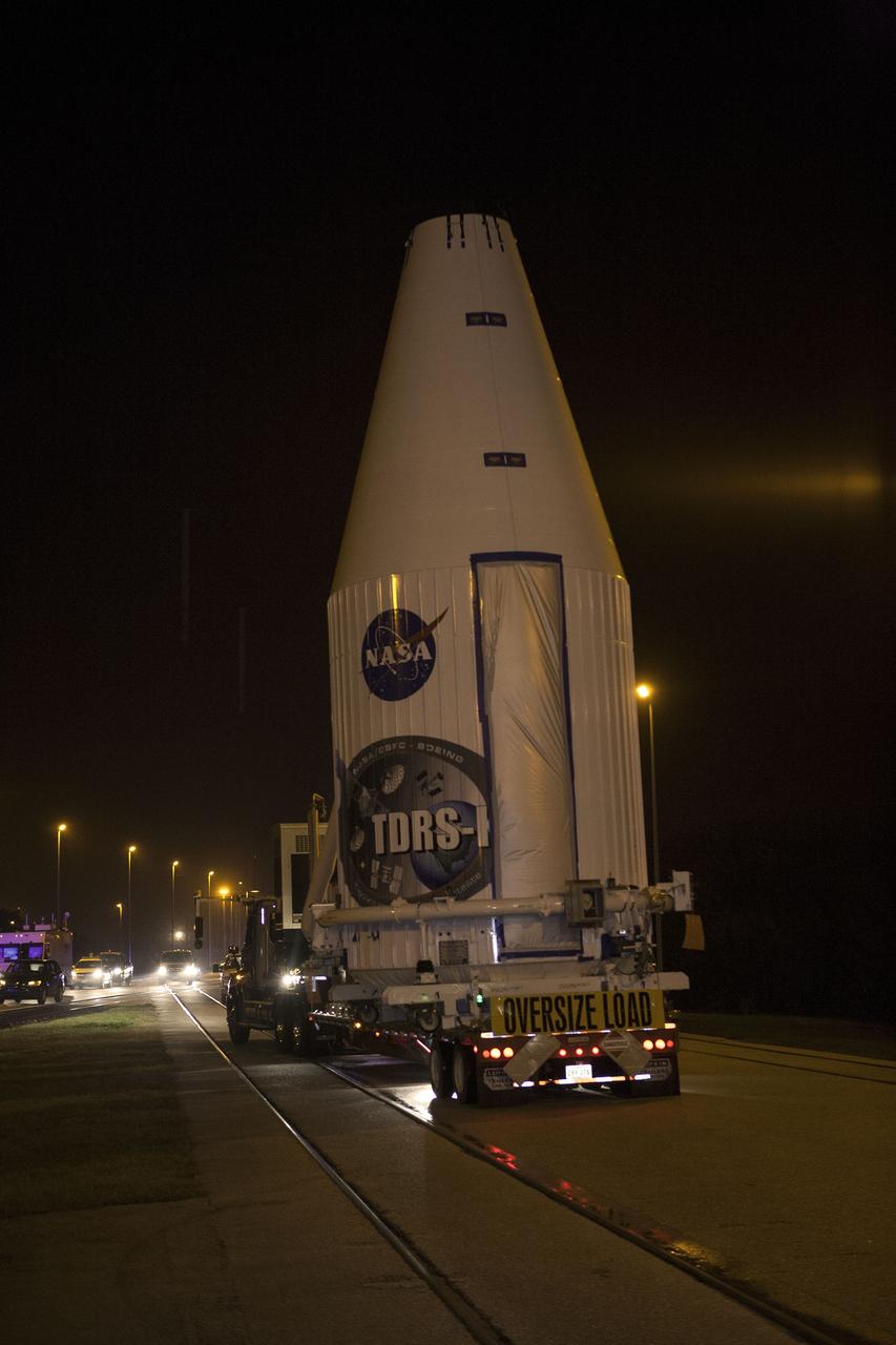 CAPE CANAVERAL, Fla. –NASA's Tracking and Data Relay Satellite, TDRS-K, enclosed in its payload fairing, passes through the Launch Complex 39 area at NASA's Kennedy Space Center as it travels from the Astrotech payload processing facility in Titusville, Fla., to its launch site. TDRS-K will lift off atop a United Launch Alliance Atlas V rocket from Cape Canaveral Air Force Station's Space Launch Complex 41. The TDRS-K spacecraft is part of the next-generation series in the Tracking and Data Relay Satellite System, a constellation of space-based communication satellites providing tracking, telemetry, command and high-bandwidth data return services. For more information, go to http://www.nasa.gov/tdrs Photo credit: NASA/Glenn Benson